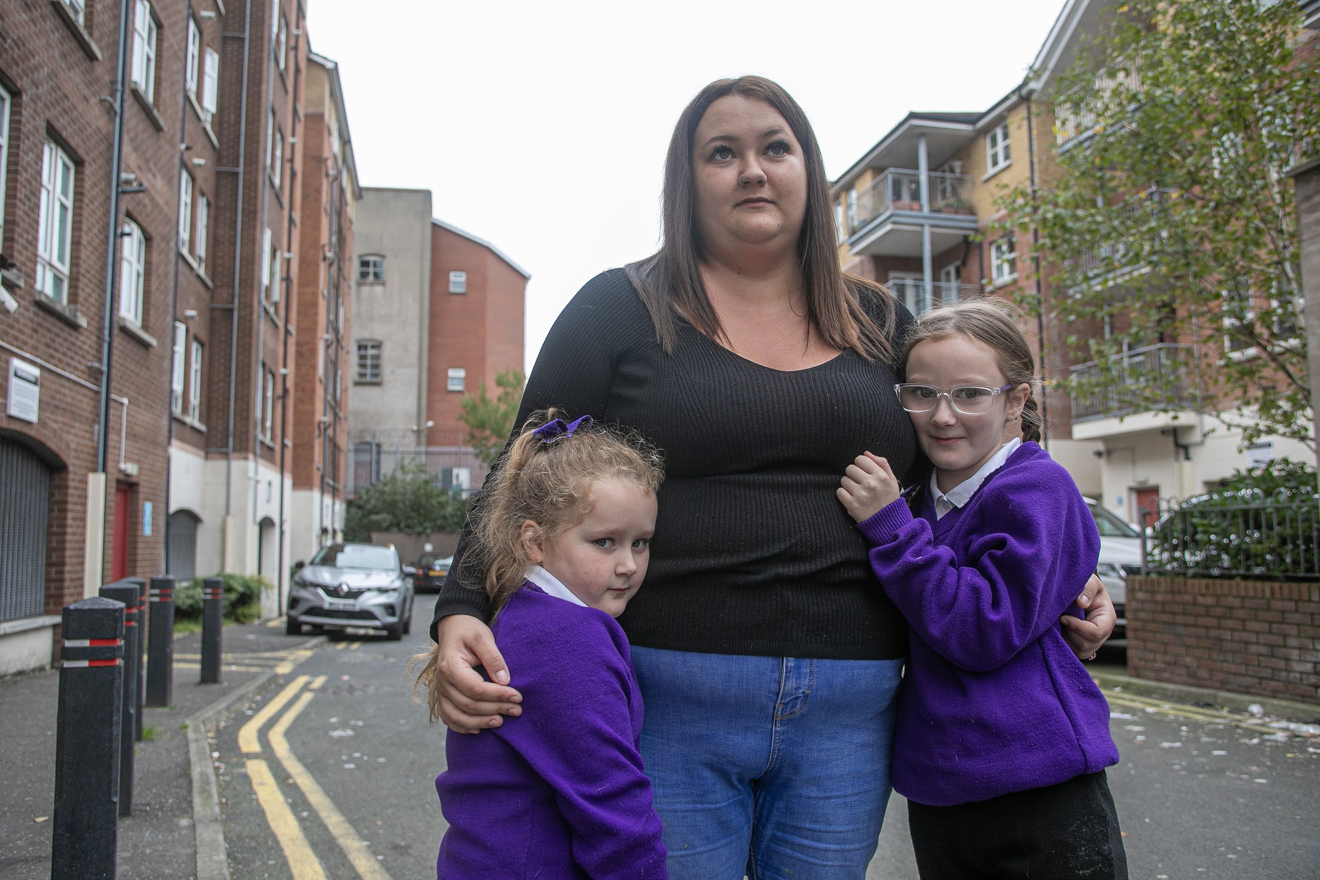 LIVING IN FEAR: Giovanna O\'Connor with daughters Mia and Vittoria outside the Springmeadow complex on the Springfield Road