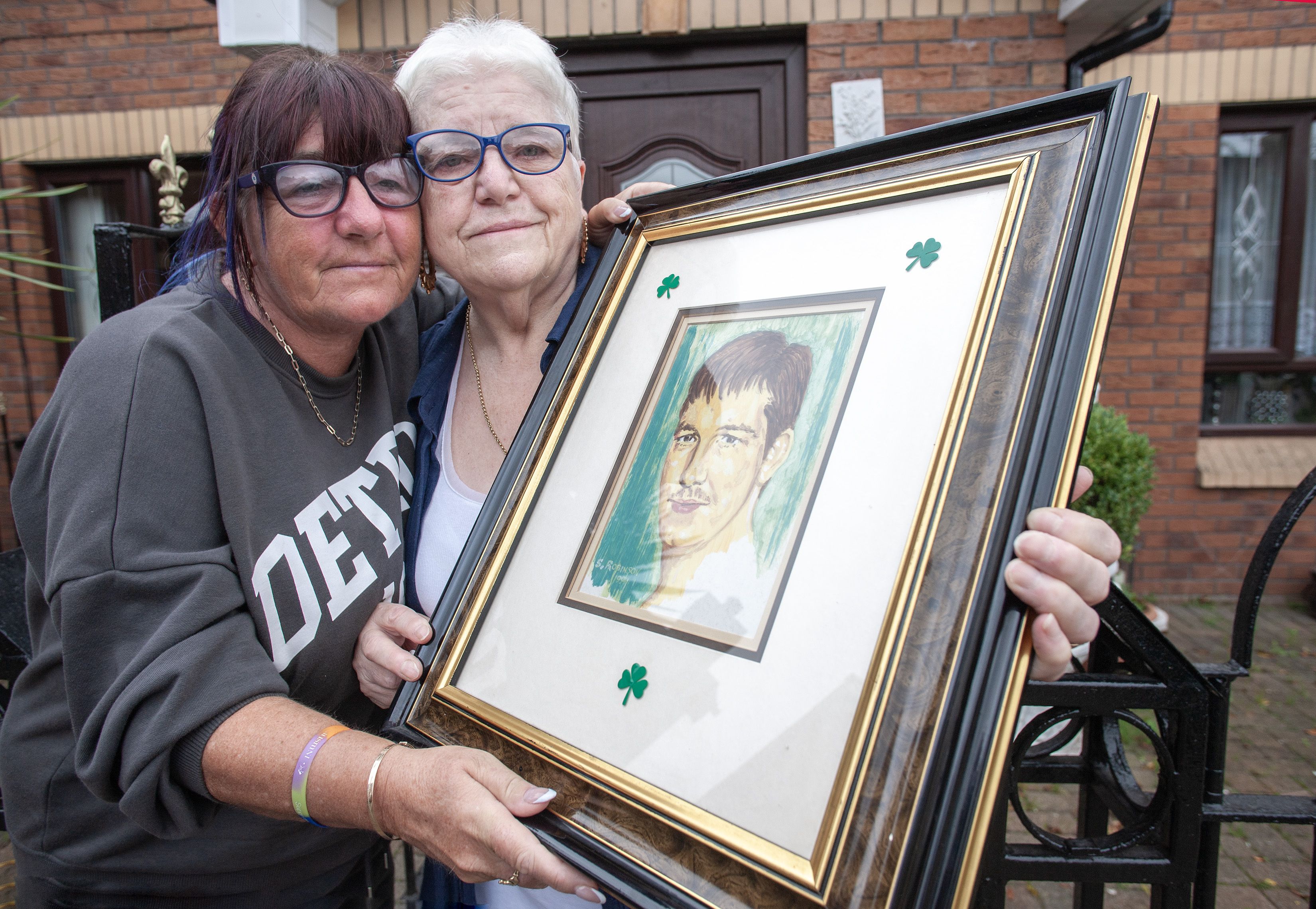 30 YEARS ON: Patrick\'s sister, Emily and mum, also Emily hold a framed photograph of Patrick