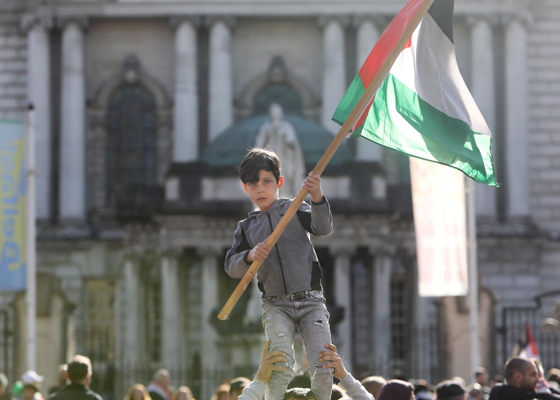 PROTEST: A young boy waves a Palestinian flag