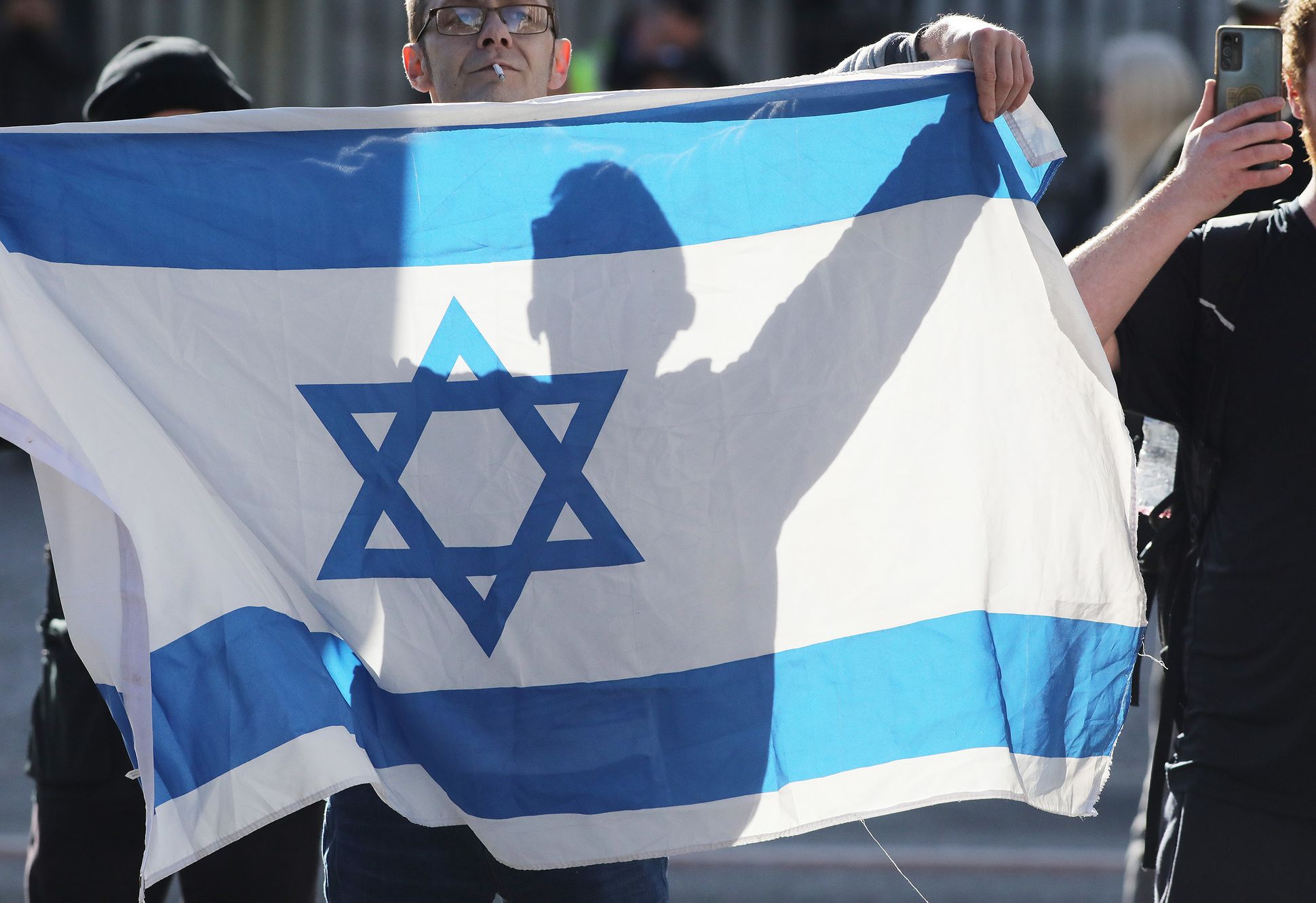 PROTEST: An Israel supporter waves the Israeli flag