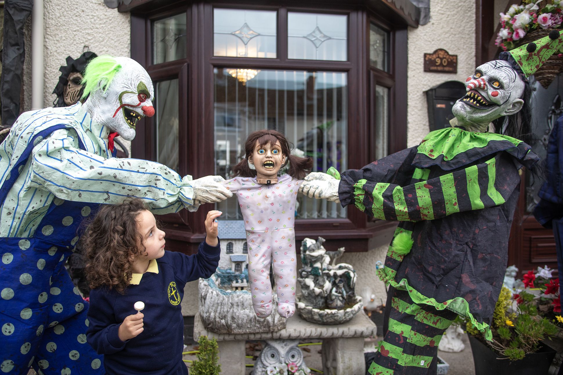 SPOOKY: A child examines a pair of the Halloween statues