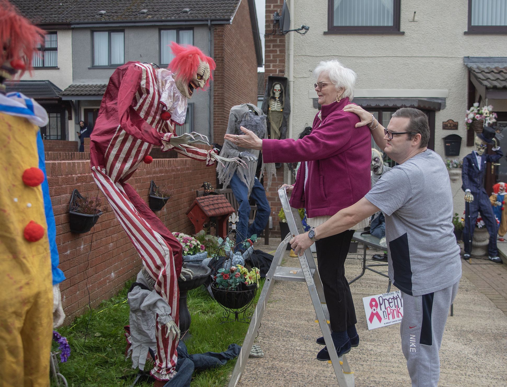 GOOD CAUSE: Philomena and John McCloskey putting up one of their spooktacular statues, which will raise money for Pretty in Pink