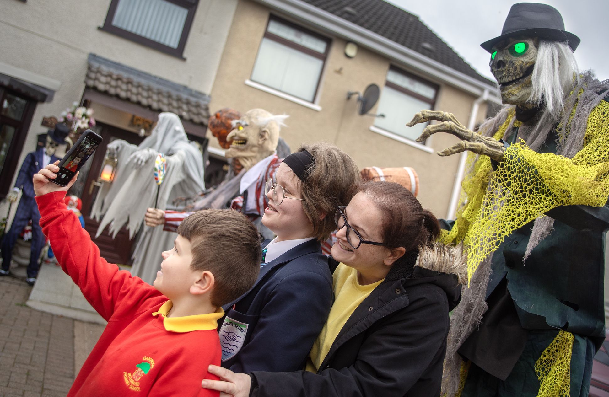 SPOOKY: A family take a selfie with one of the McCloskey's Halloween statues