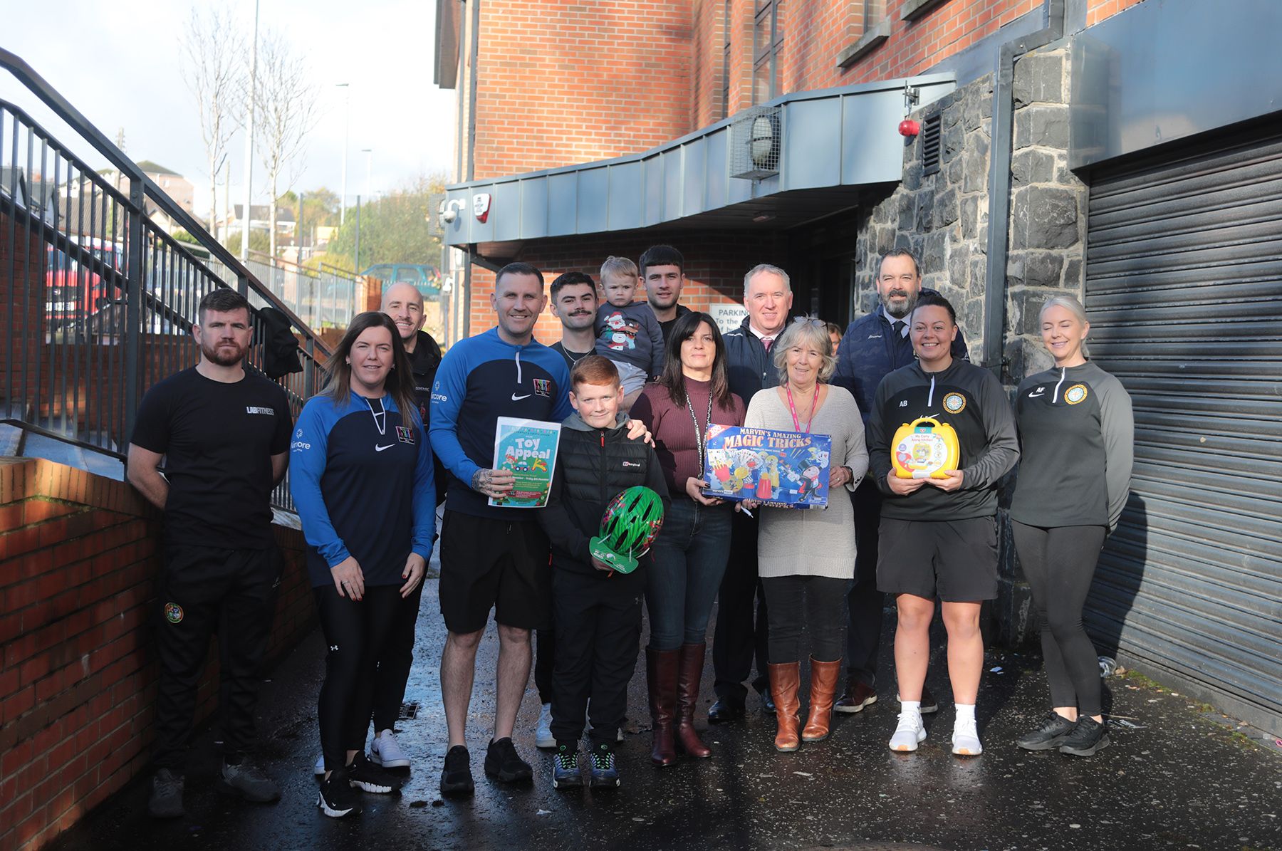 TOYS: Glen Parent Youth Group members Robert Sands and Karen Nugent with Principals Paddy McCabe and Séamus Ó Tuama and local parents