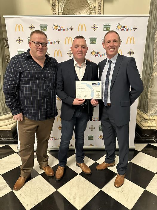 Belfast Swifts\' chairman, Gerard Rooney and secretary, Kevin Shannon receiving The Irish FA Foundation People & Clubs Accreditation presented by Jordan Reid at the City Hall
