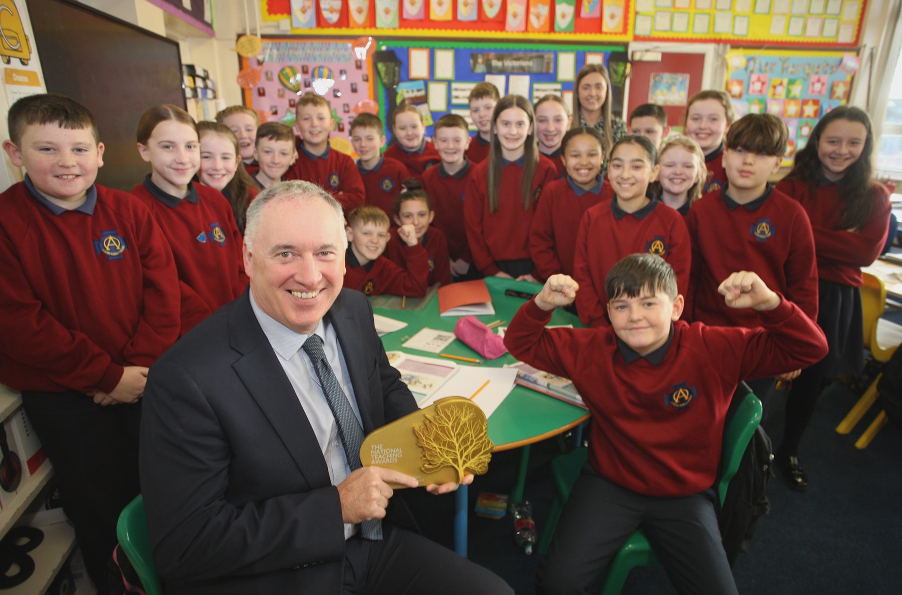 GOLDEN PRIZE: Principal Paddy McCabe with staff and pupils from St Oliver Plunkett Primary School with their Gold Award from Pearson\'s