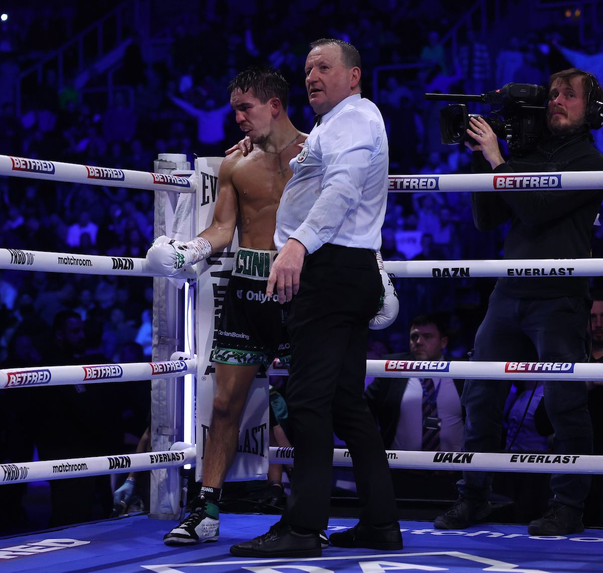Referee Howard Foster consoles Michael Conlan having stopped the fight on Saturday 