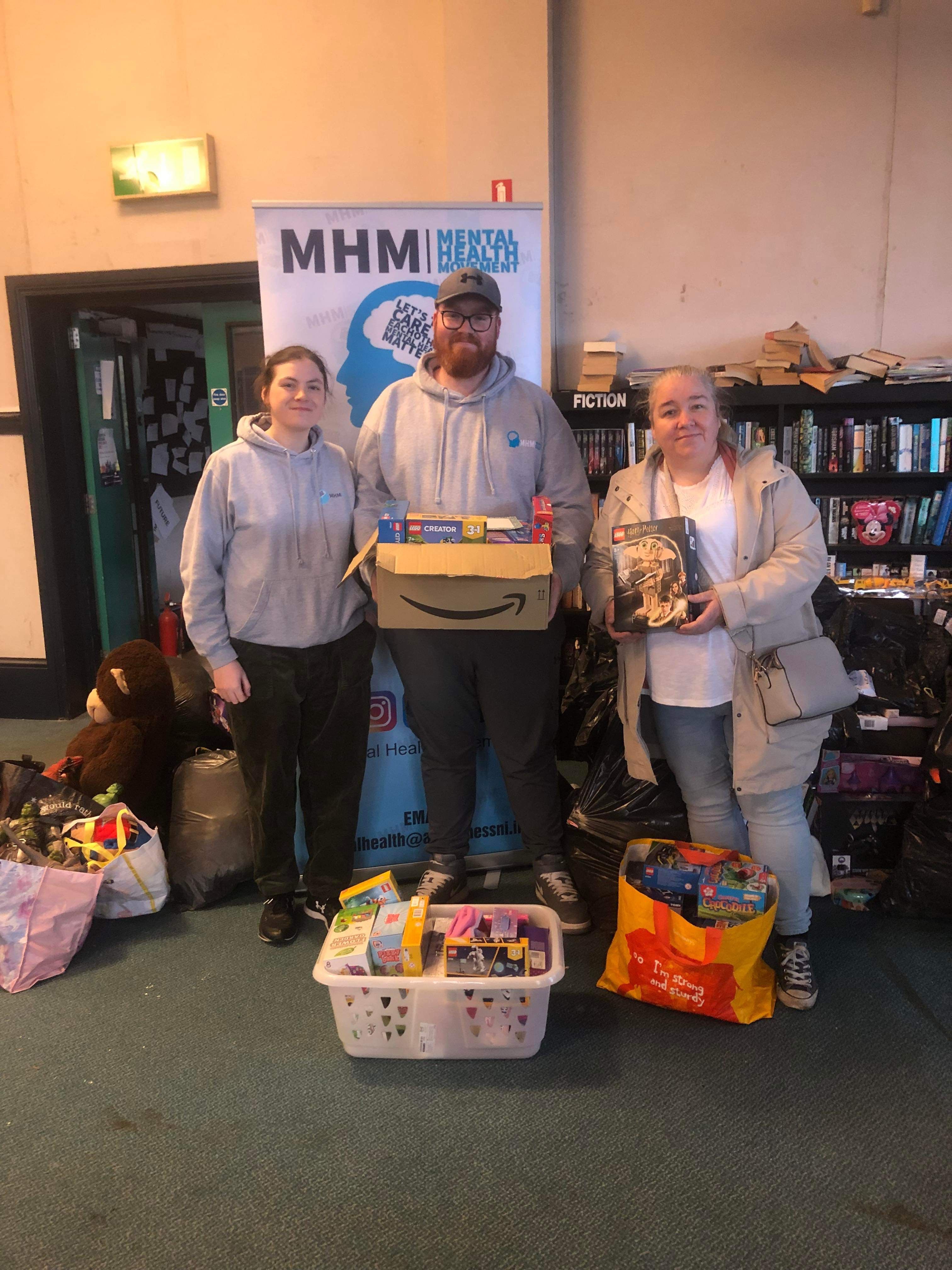 TOY APPEAL: Caoimhin McNulty from Mental Health Movement receives a donation of toys and cash from Anne and Maria McKenna