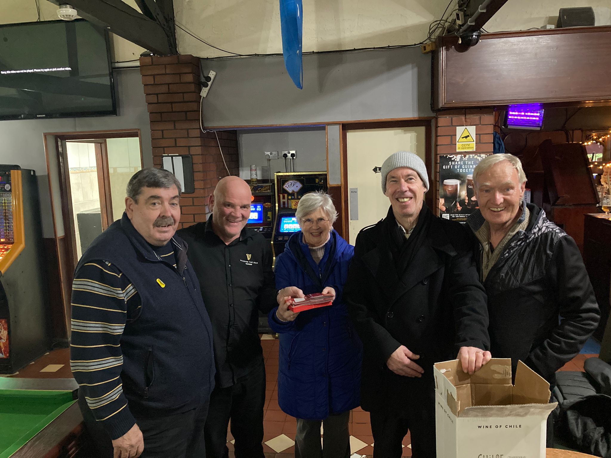 GIVING SPIRIT: Billy Hitchens of the Laure Glen (left) makes a festive contribution to the coffers of the Twinbrook conference of St Vincent de Paul. Dan Turley is on right. 