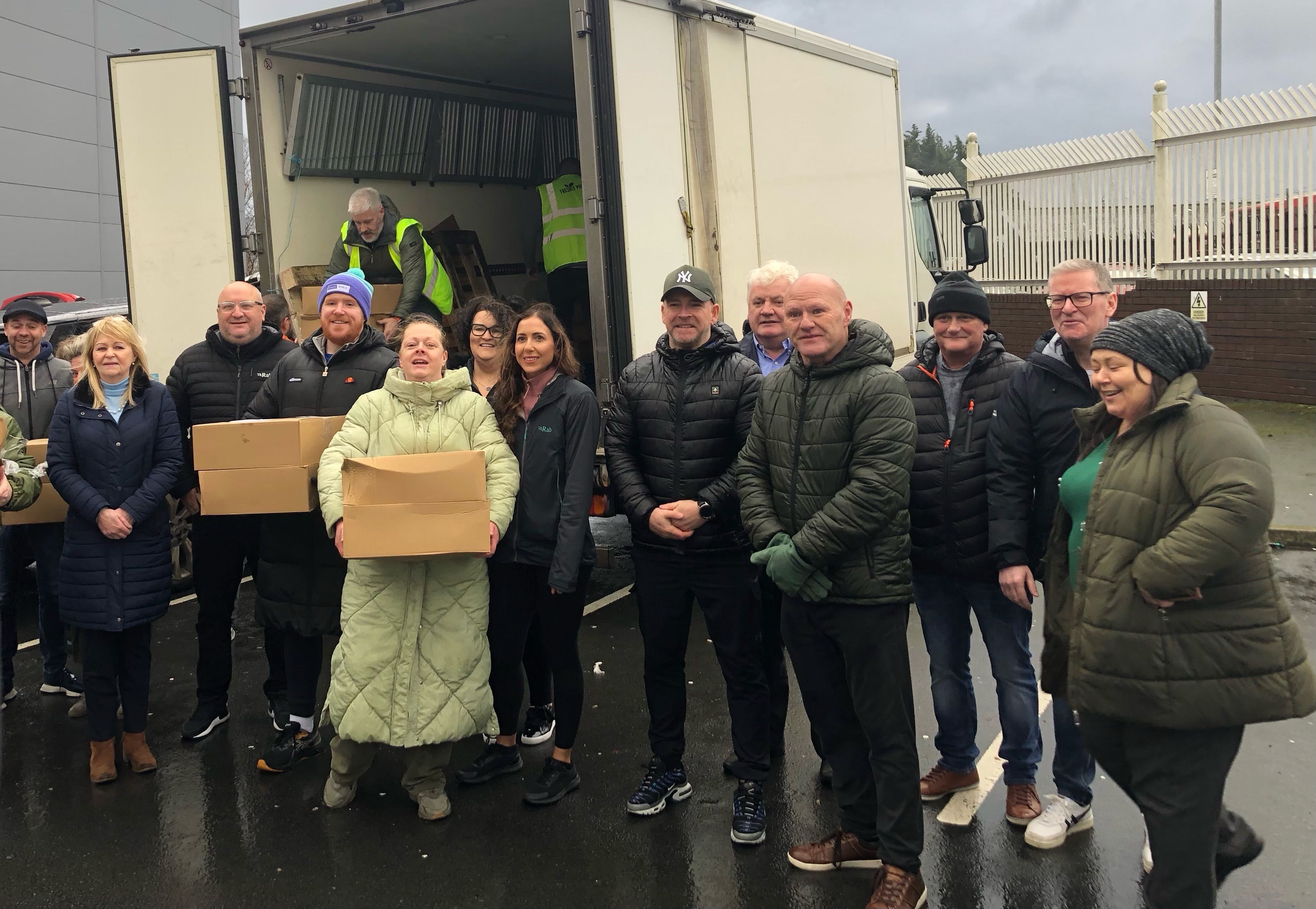 CHRISTMAS MEALS: Volunteers and family support hub workers from across West Belfast and MP Paul Maskey helping to distribute food parcels for families this Christmas