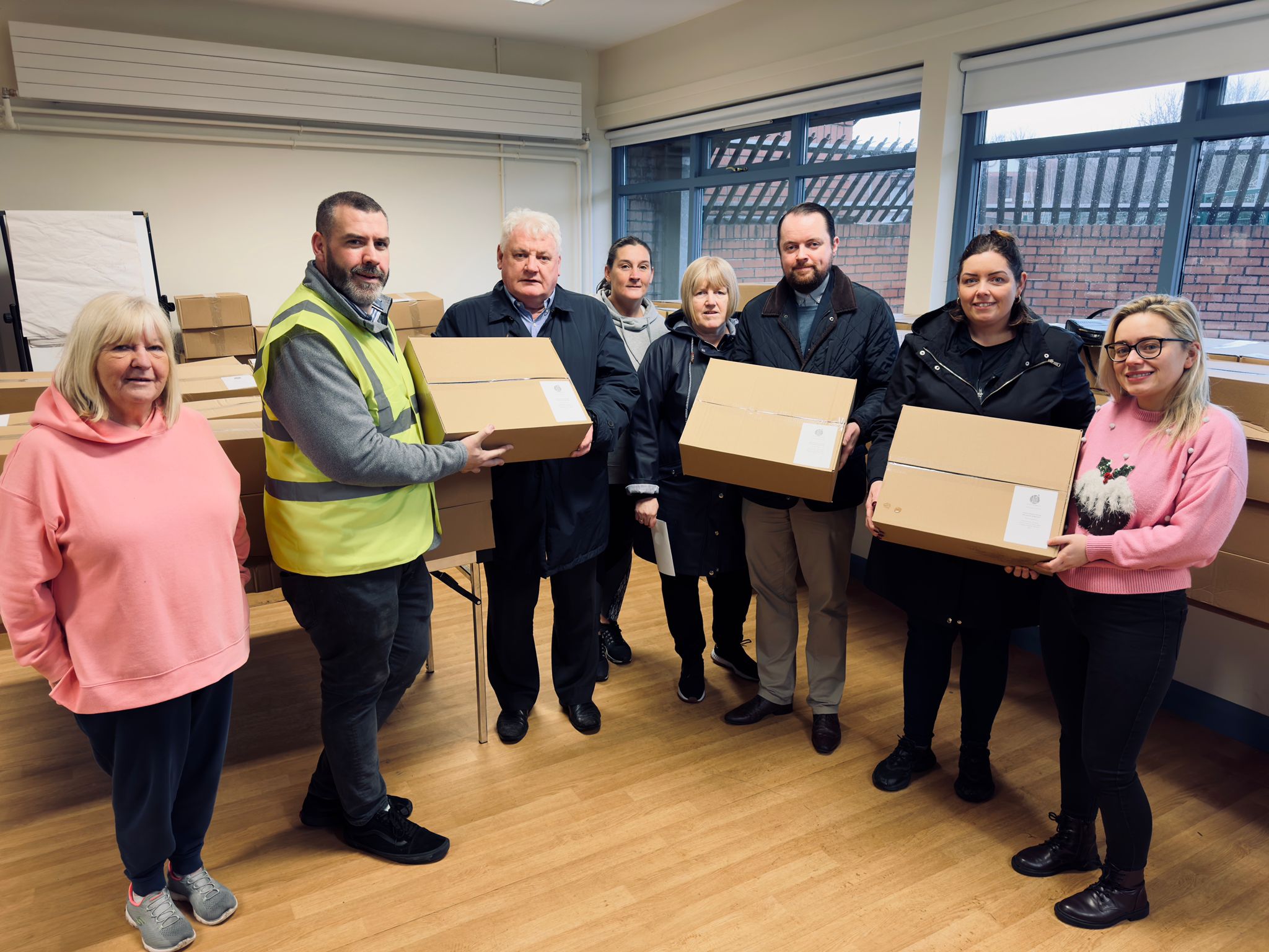 HO HO HO! Santa came early for over 100 South Belfast families thanks to the Market Development Association and Straben Ltd. Included in photo are Kevin McKay (third from left), Fionntán Hargey (third from right) and Deirdre Hargey (second from right) 