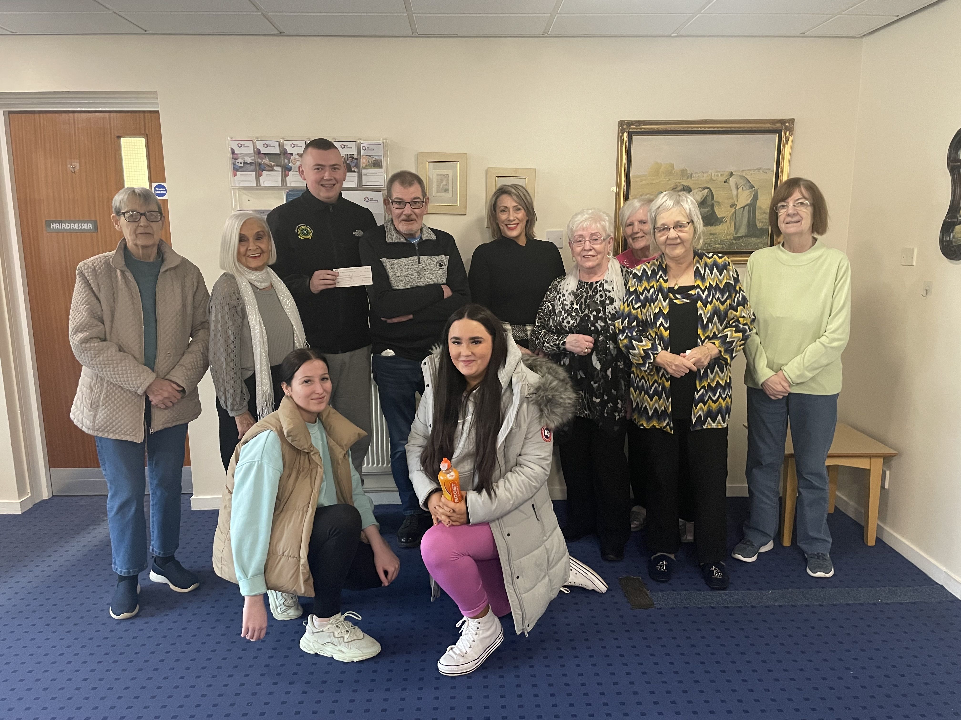 FUNDRAISER: Staff and residents of Holy Rood House presented a cheque of £700 to Ardoyne Youth Club