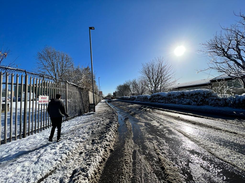 ON FOOT: Snow at the Glen Colin bus stop on the Glen Road