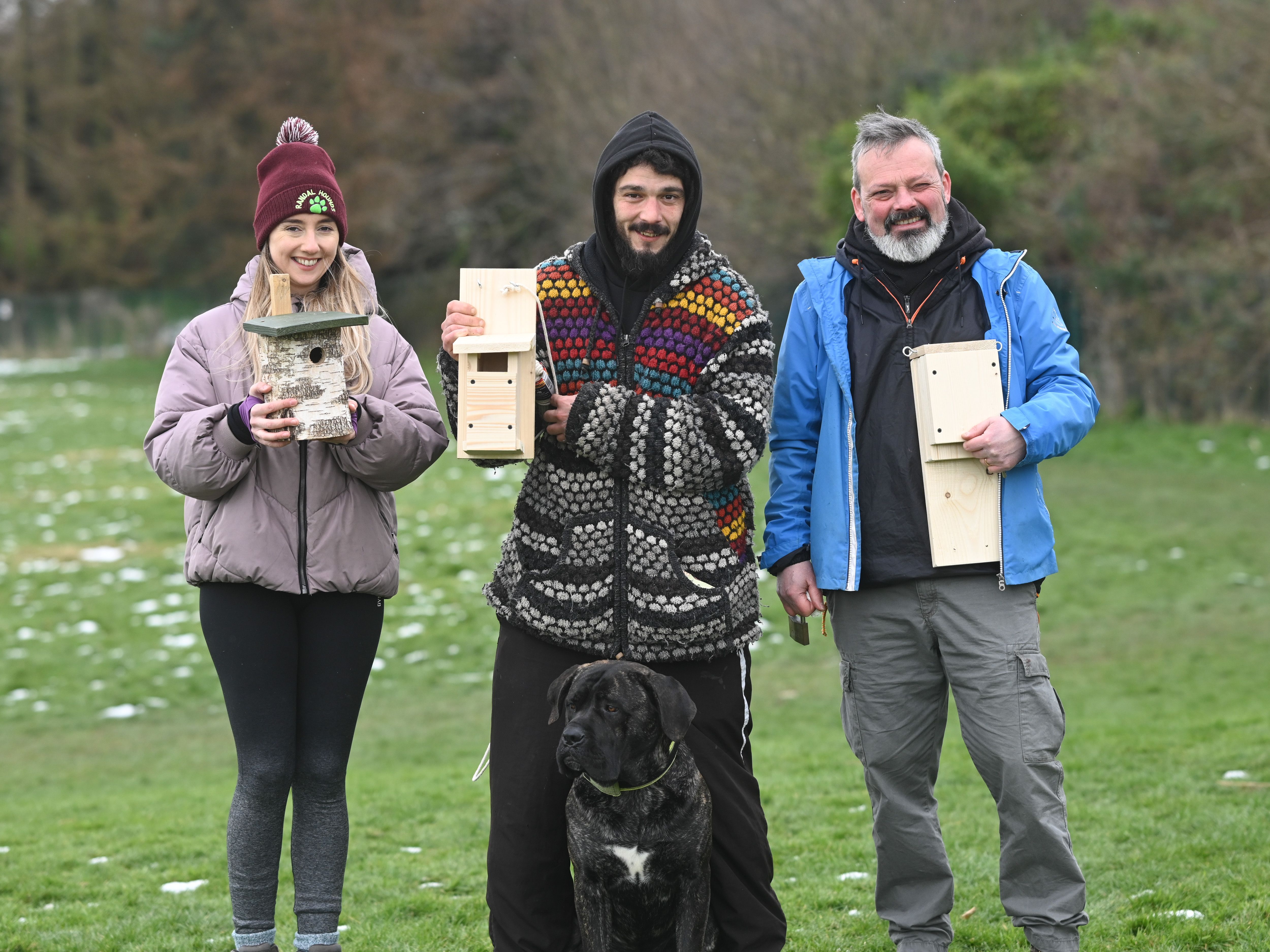 THE FIELD: Alicia, Valter, Boi the dog, and Colin Shaw with birdhouses and bat homes at the Field