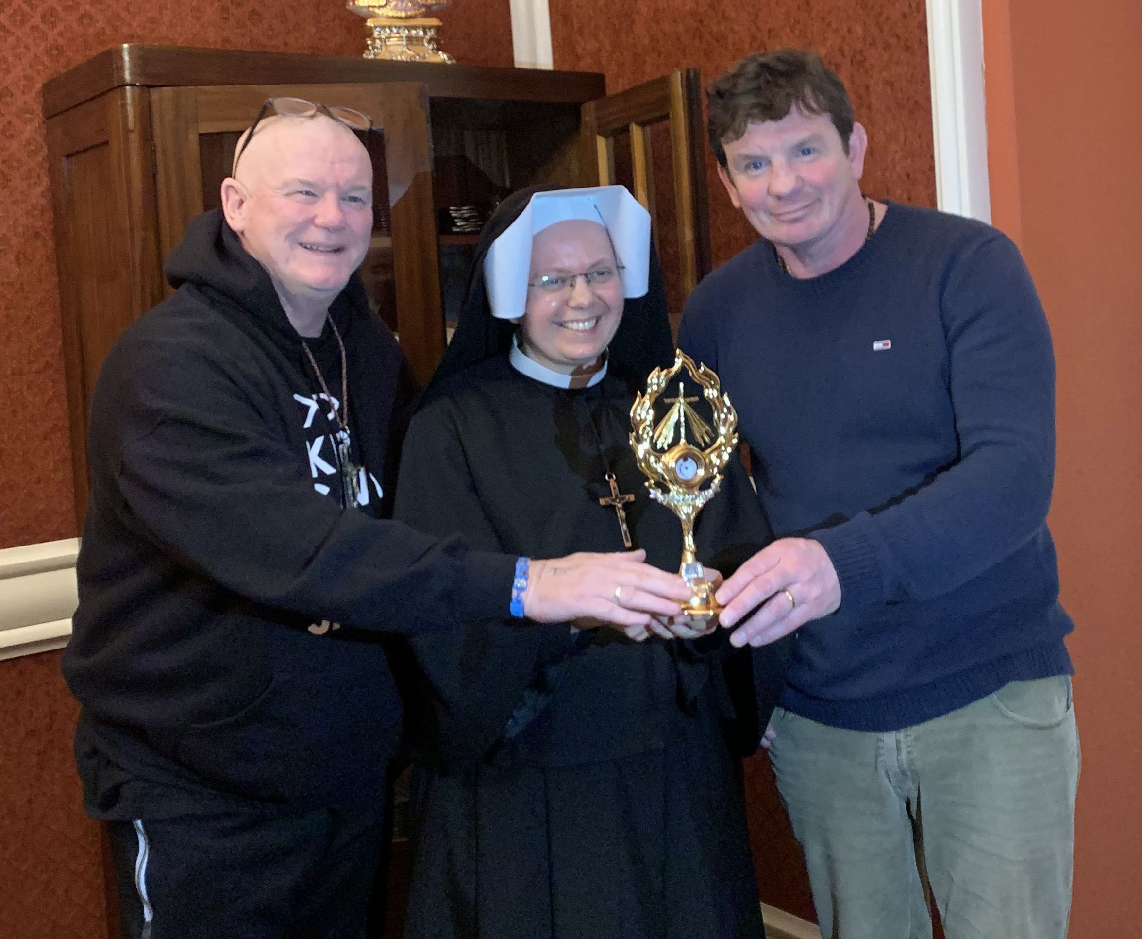 RELIC: Thomas Stewart and Stephen McCloskey from Divine Mercy Prayer Group with Sr Norberta and the relic