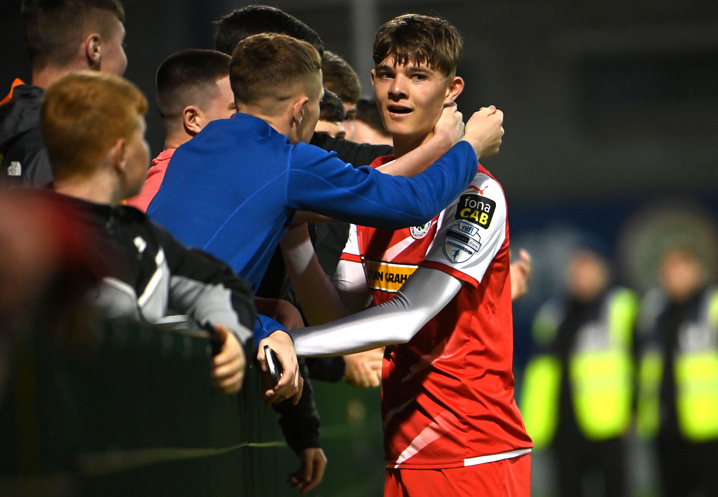 Sean Moore celebrates with Cliftonville fans after the Reds advanced into the European playoff final