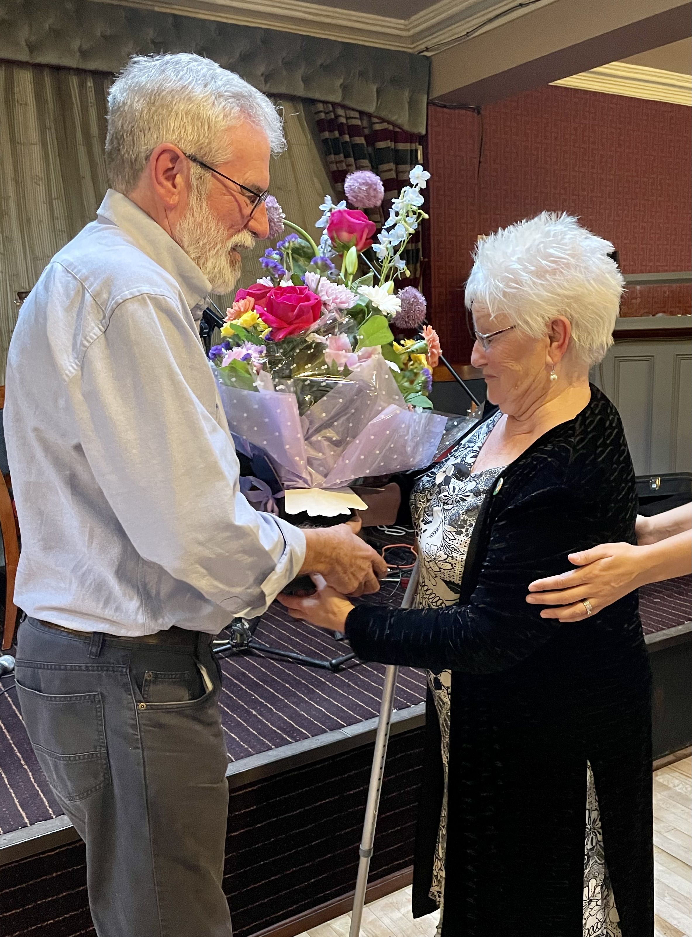 TRIBUTE: Gerry Adams presents Dinah Fullerton with a bouquet of flowers at the launch of his book about her husband Eddie