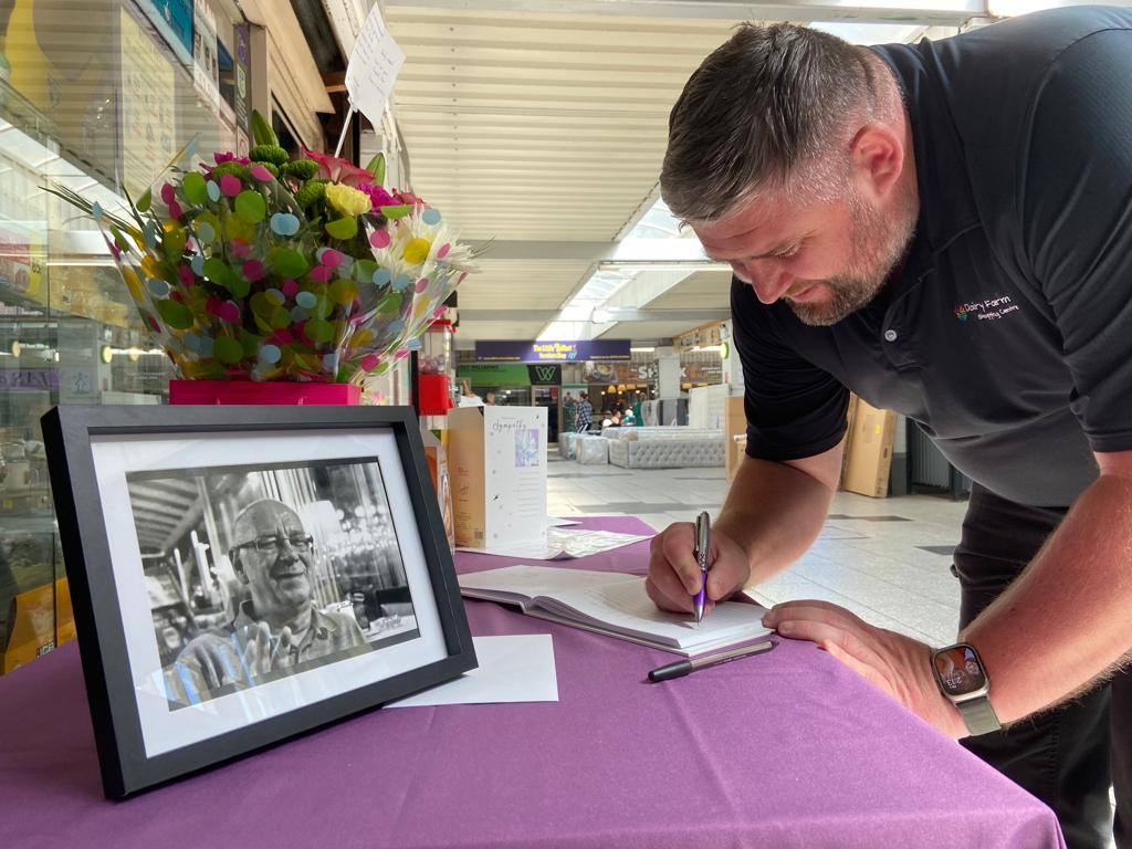 TRIBUTE: Dairy Farm staff member Seán Dines signs book of condolences for Robert Laverty