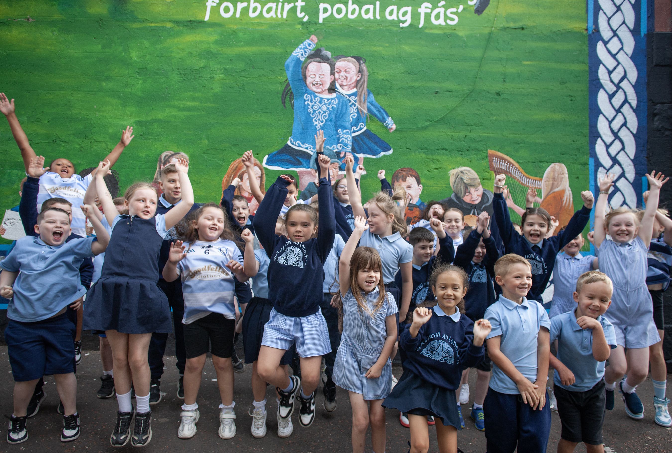 MAITH SIBH: Pupils at Gaelscoil an Lonnáin jump for joy at their new wall
