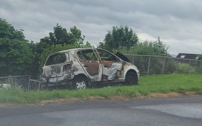 BURNT OUT: Extensive damage was caused to a car after it was set alight in the Springfield Road area on Friday night