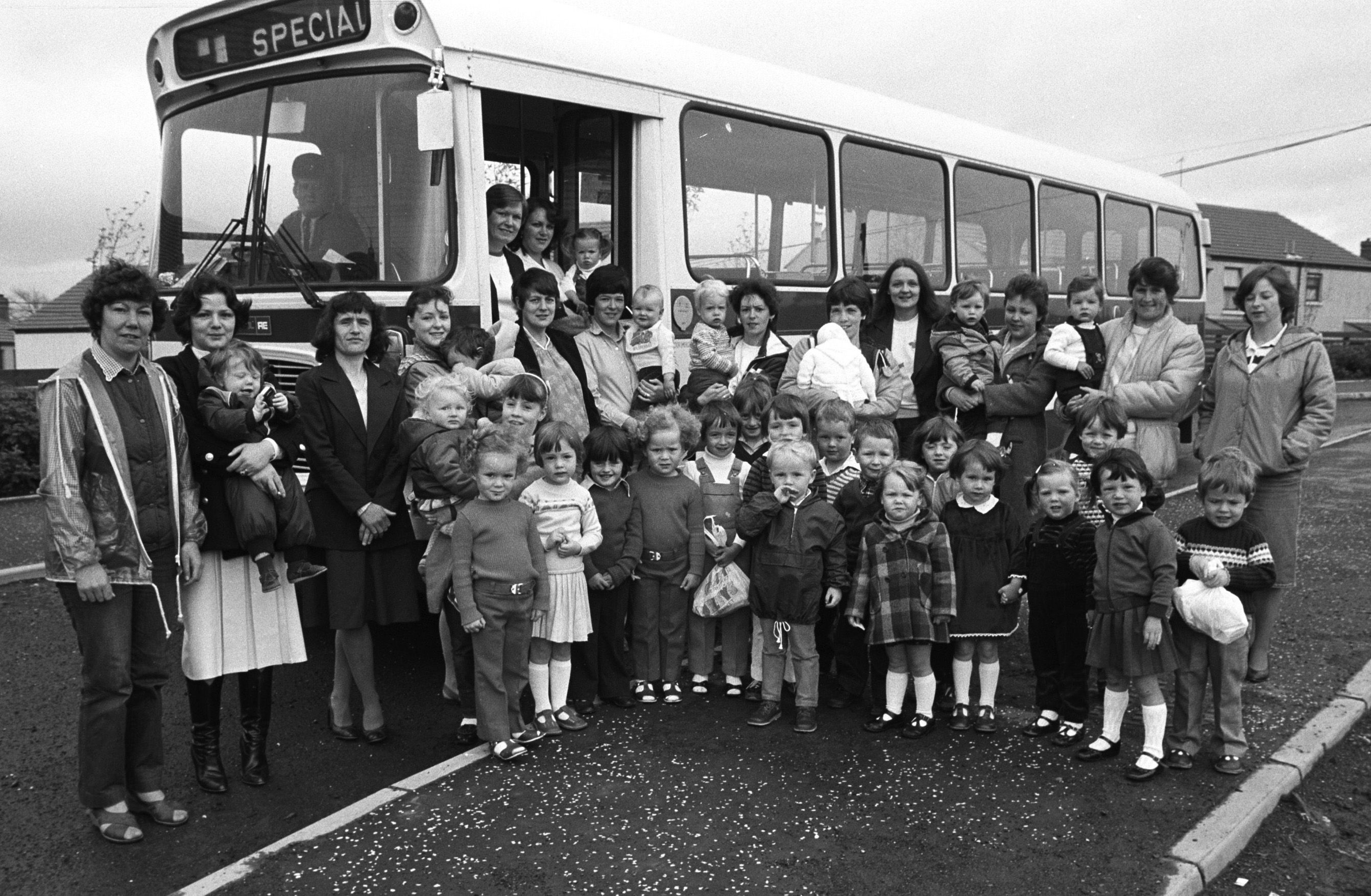 ON THE BUSES: Volunteer Services Bureau trip for Poleglass parents and children to Crawfordsburn, including  play leaders May Forbes and Patricia McManus