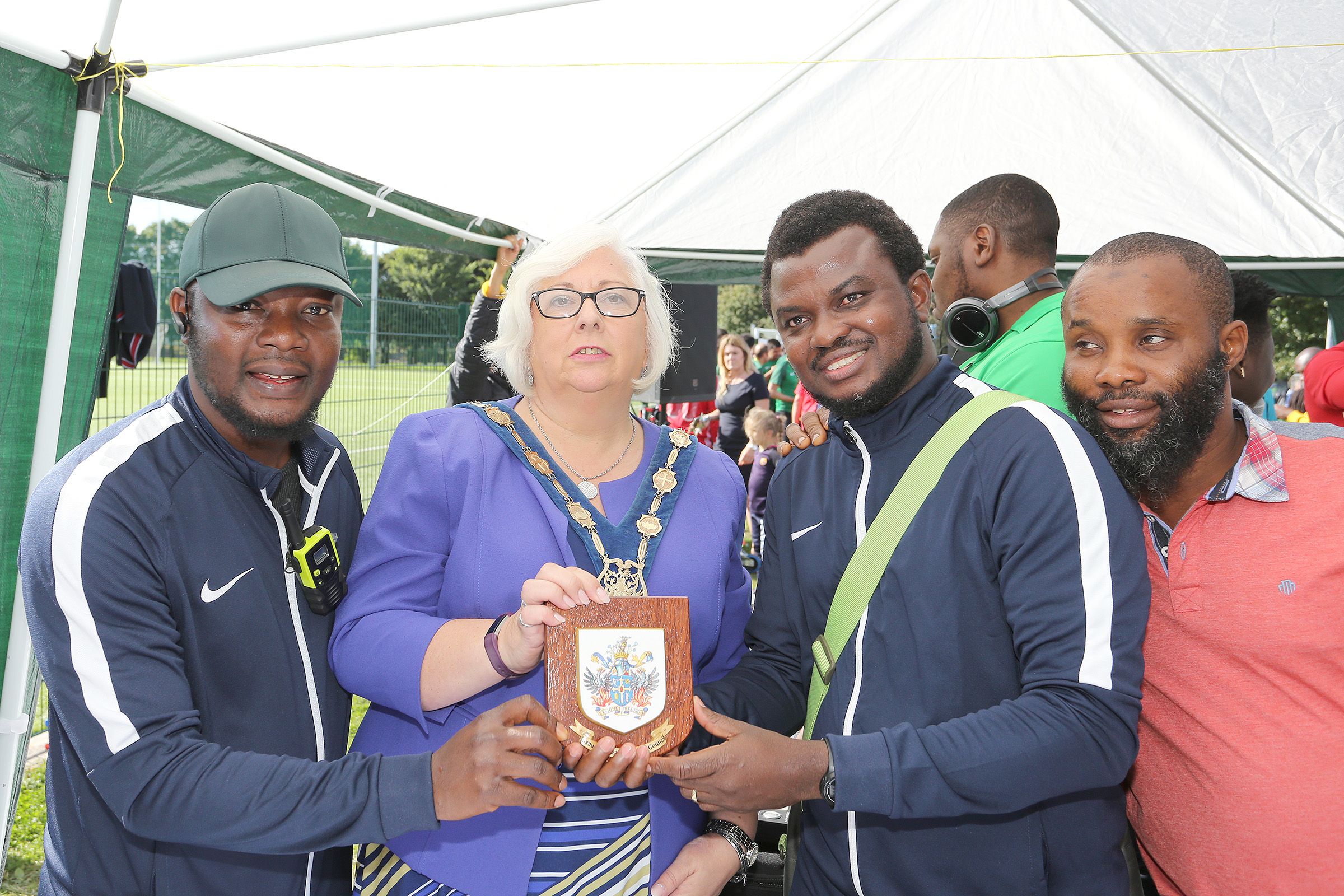 PLAYING OUR PART: Inter-Community Football League Final and Family Fun day in 2017 organised by African-Caribbean Sports Forum NI pic: Organisers Jay Emmanuel and Adekanmi Abayomi present to Dep Mayor of Lisburn and Castlereagh Hazel Legge