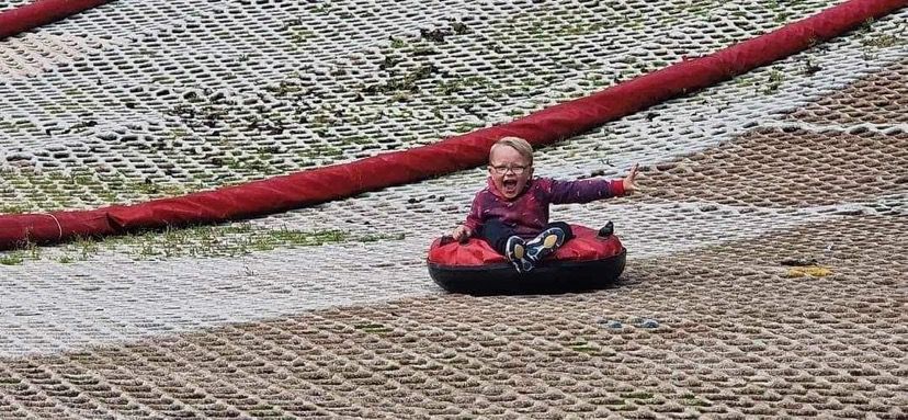 SUMMER FUN: Rowan Nugent trying his hand at snowtubing as part of Carrick Hill Junior Summer Scheme