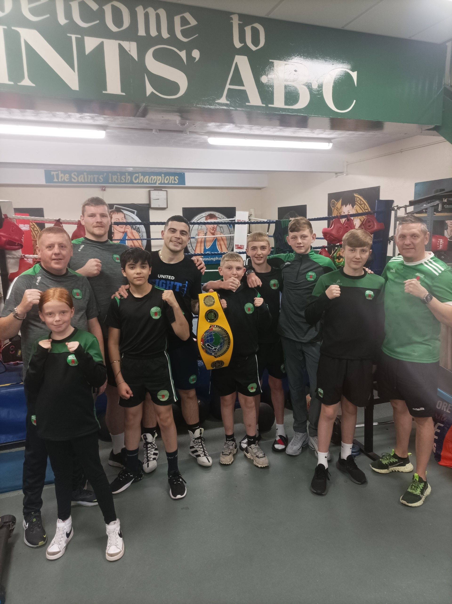 Nathan Watson was back at his native Saints ABC with the Australasian middleweight belt on Monday evening where he was greeted by coaches Liam and Harry Cunningham Jnr, plus she of the club\'s young boxers