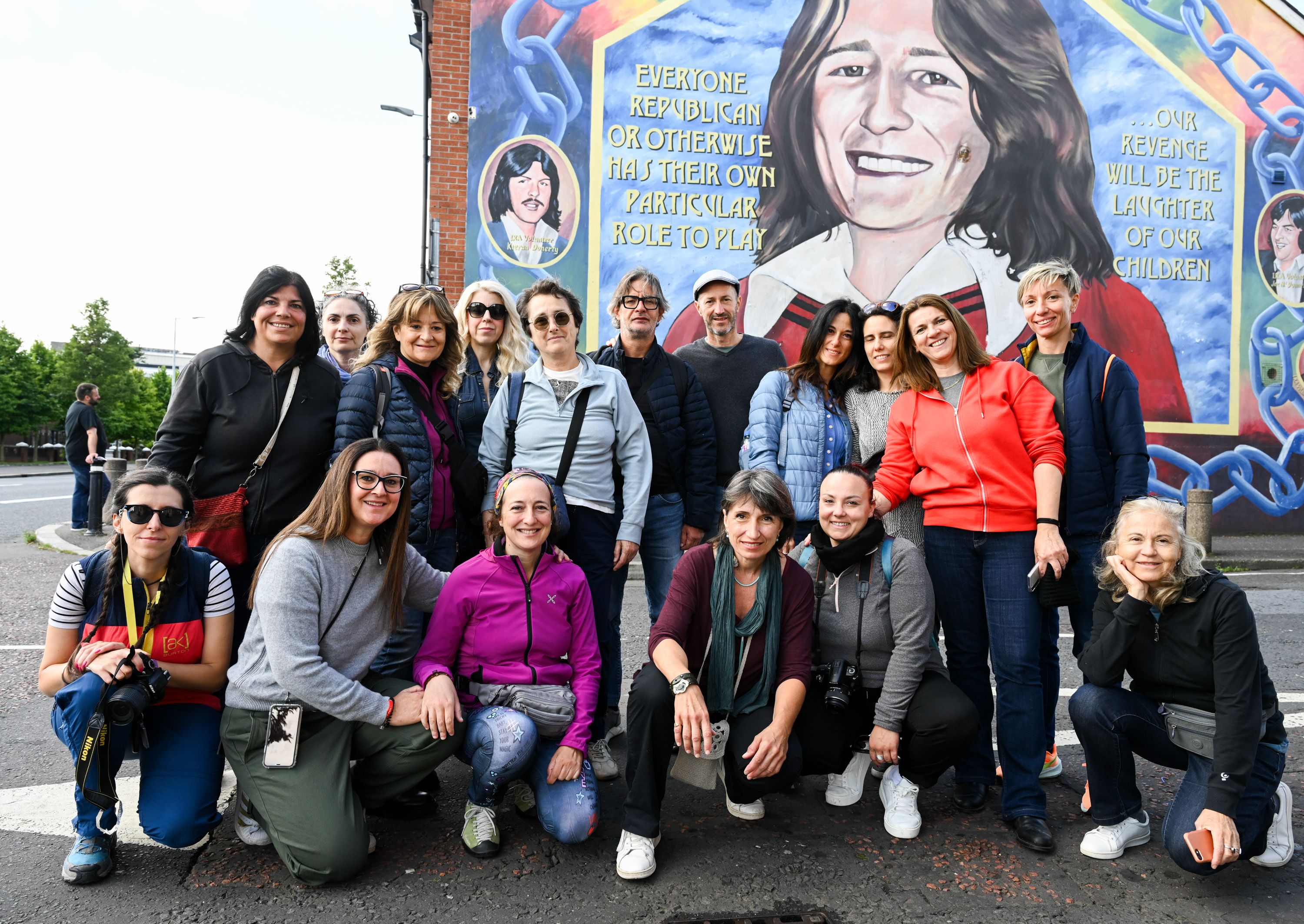 TOUR: Michael Phillips (centre, right) at the Bobby Sands mural with the group of Italians who were visiting Belfast