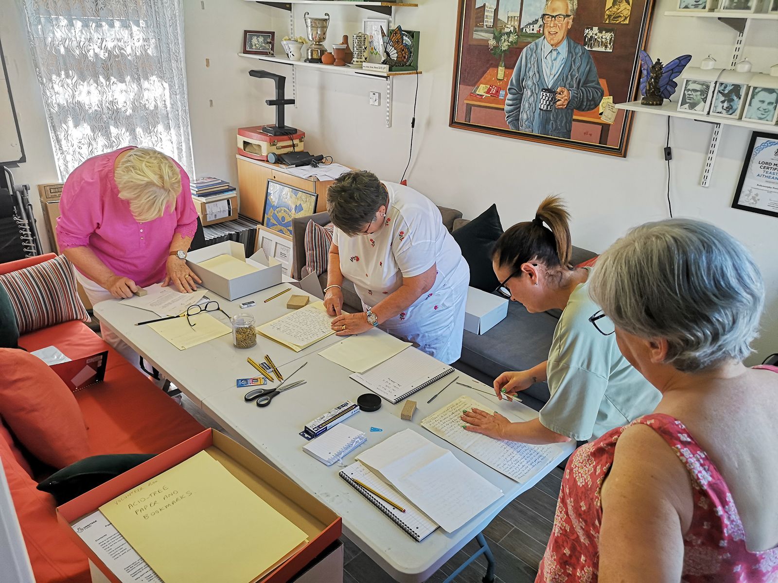 Volunteers working on our archive project under the watchful eye of Fr Des himself