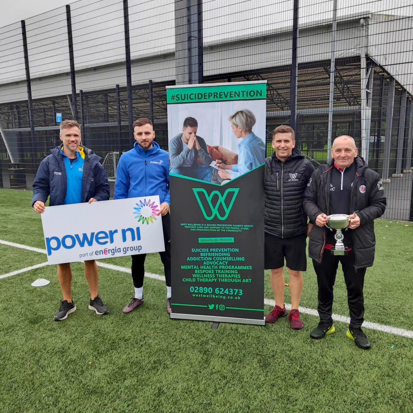 Pictured (L-R) is Tony O’Neill (Ford Football Club player), Ciaran Brown (Power NI representative and Ford Football Club player), and Gerard Mallon and Brian McCabe from the West Wellbeing charity.