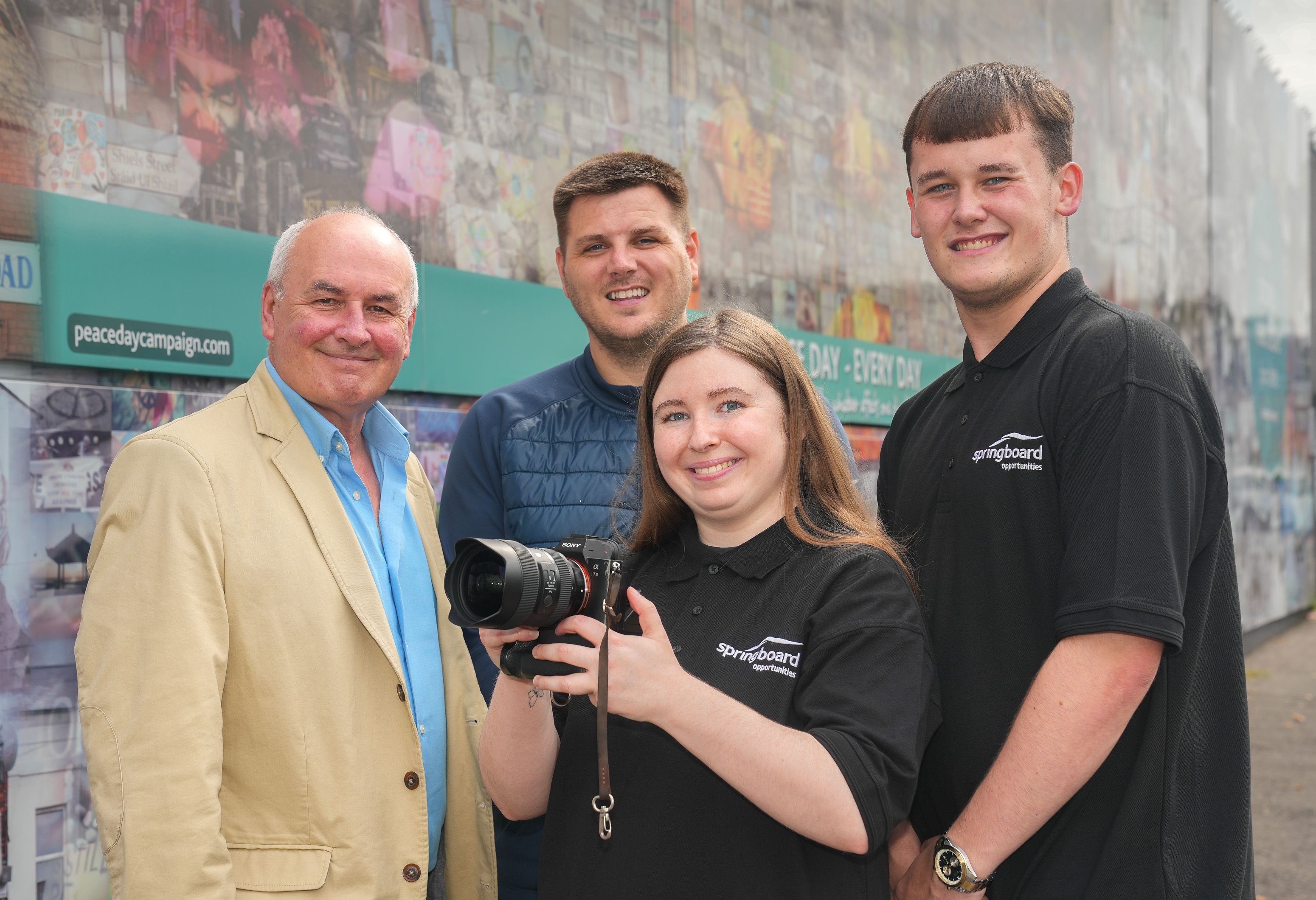 IN THE FRAME: Aoife Lafferty at the peace-line gates at Northumberland Street with Dr Sean Brennan (Good Relations Officer, Housing Executive), Sam McCaw (Springboard Opportunities) and Stephen McAllister