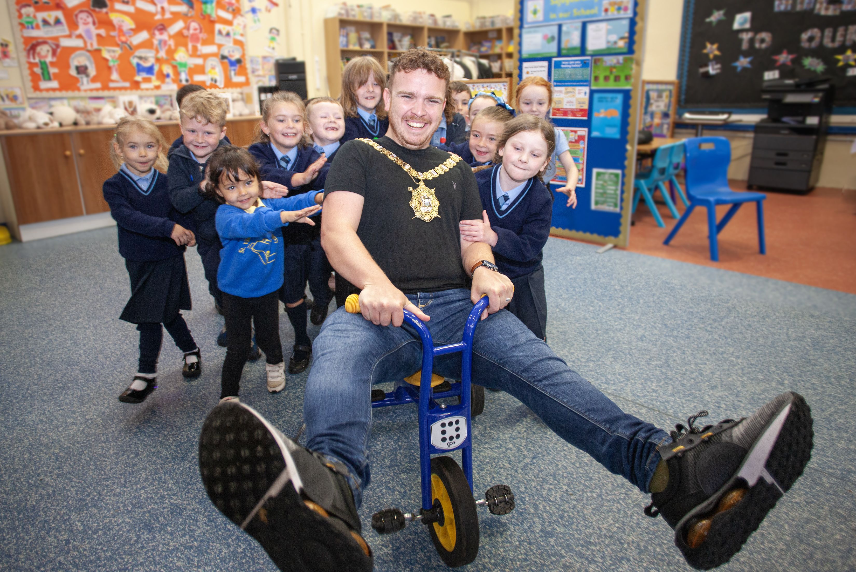 BACK AT SCHOOL: Lord Mayor Councillor Ryan Murphy is pushed by children from St Vincent de Paul\'s PS during his visit