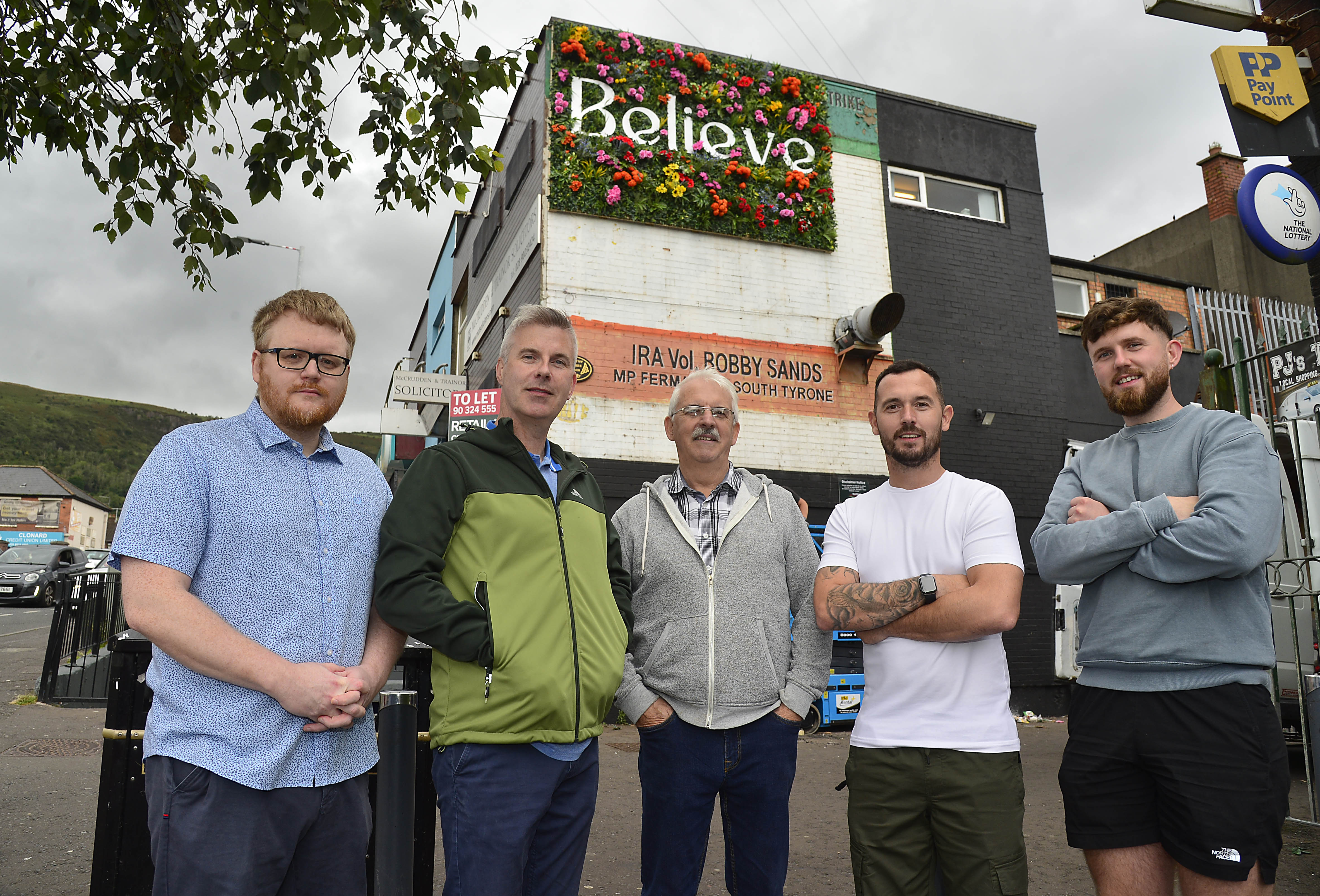 MURAL: Stuart Lavery (left), Housing Executive, with Stevie Corr, Falls Community Council, Tommy Holland, Community Development worker, Councillor Micheal Donnelly and Cónall O’Corra, Upper Springfield Development Trust