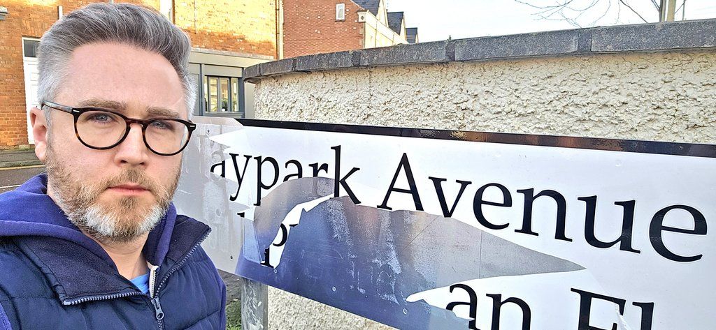 VANDALISM: SDLP Councillor Gary McKeown with the vandalised street sign on Haypark Avenue
