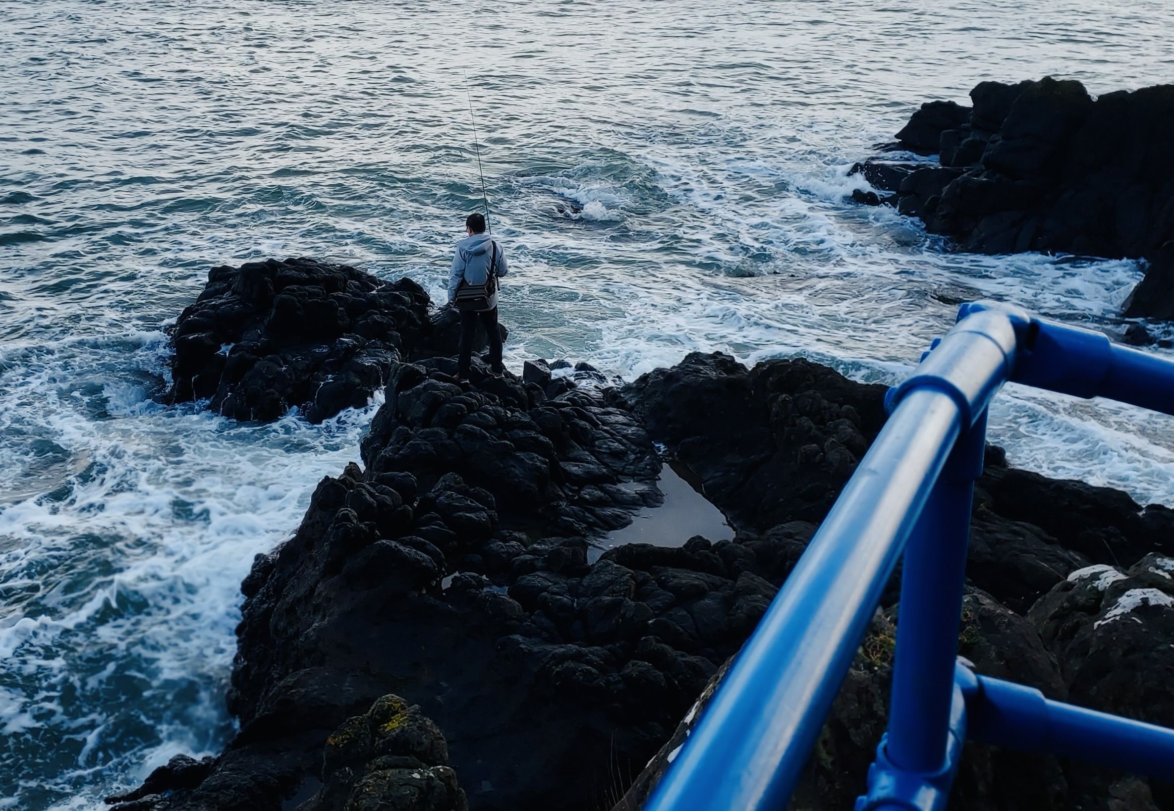 HOPEFUL: A fisherman on the rocks near Whitehead
