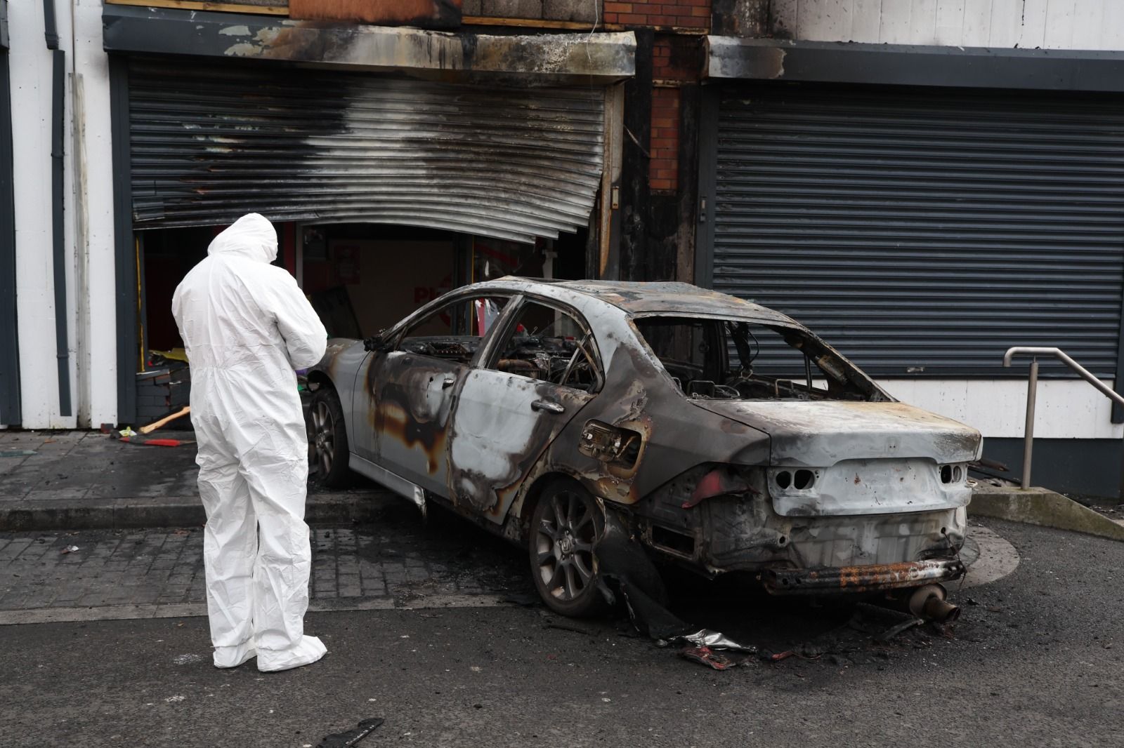 ARSON ATTACK: Forensics at Pizza Guys on the Andersonstown News on Tuesday morning