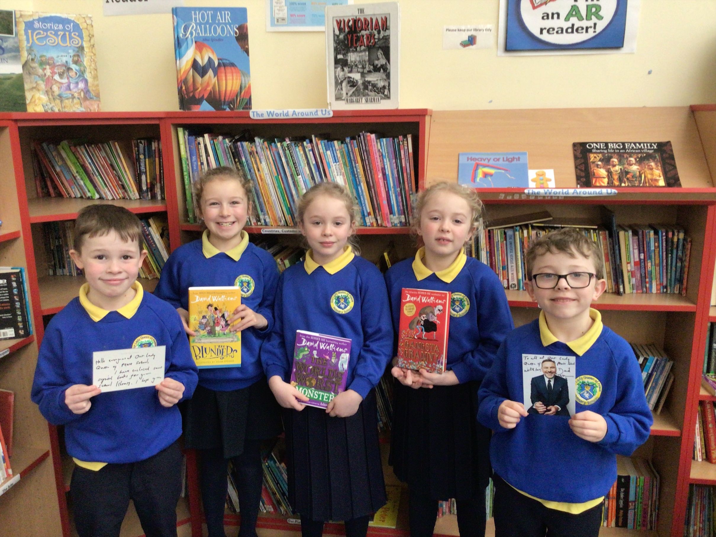 DELIGHTED: P4 pupils from Our Lady Queen of Peace PS with some of David Walliams\' books