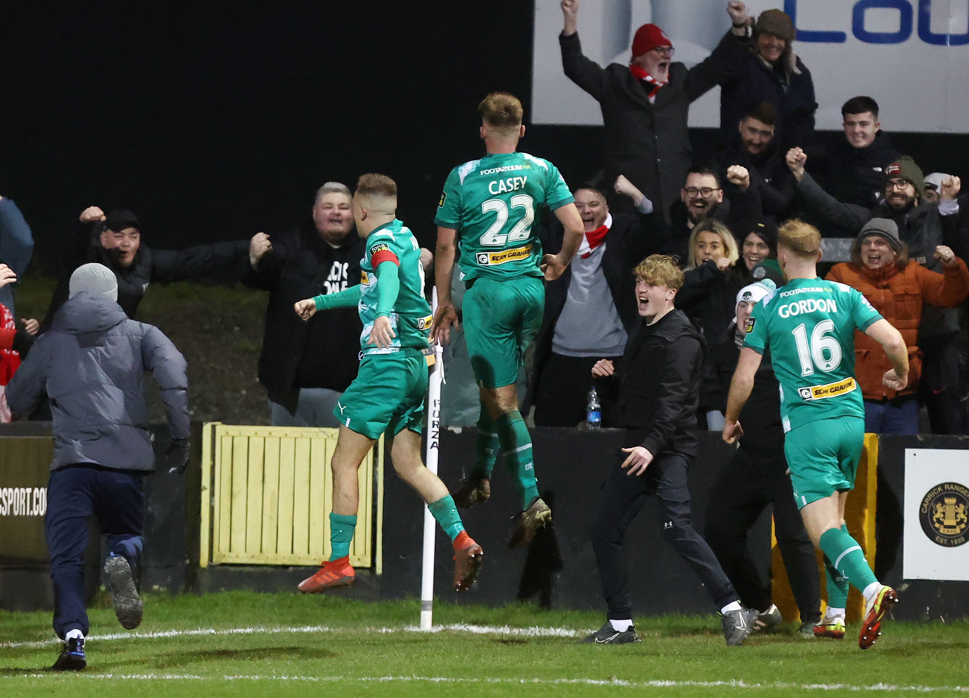 Odhran Casey and his Cliftonville team-mates run to the fans after the last-gasp winner on Friday 