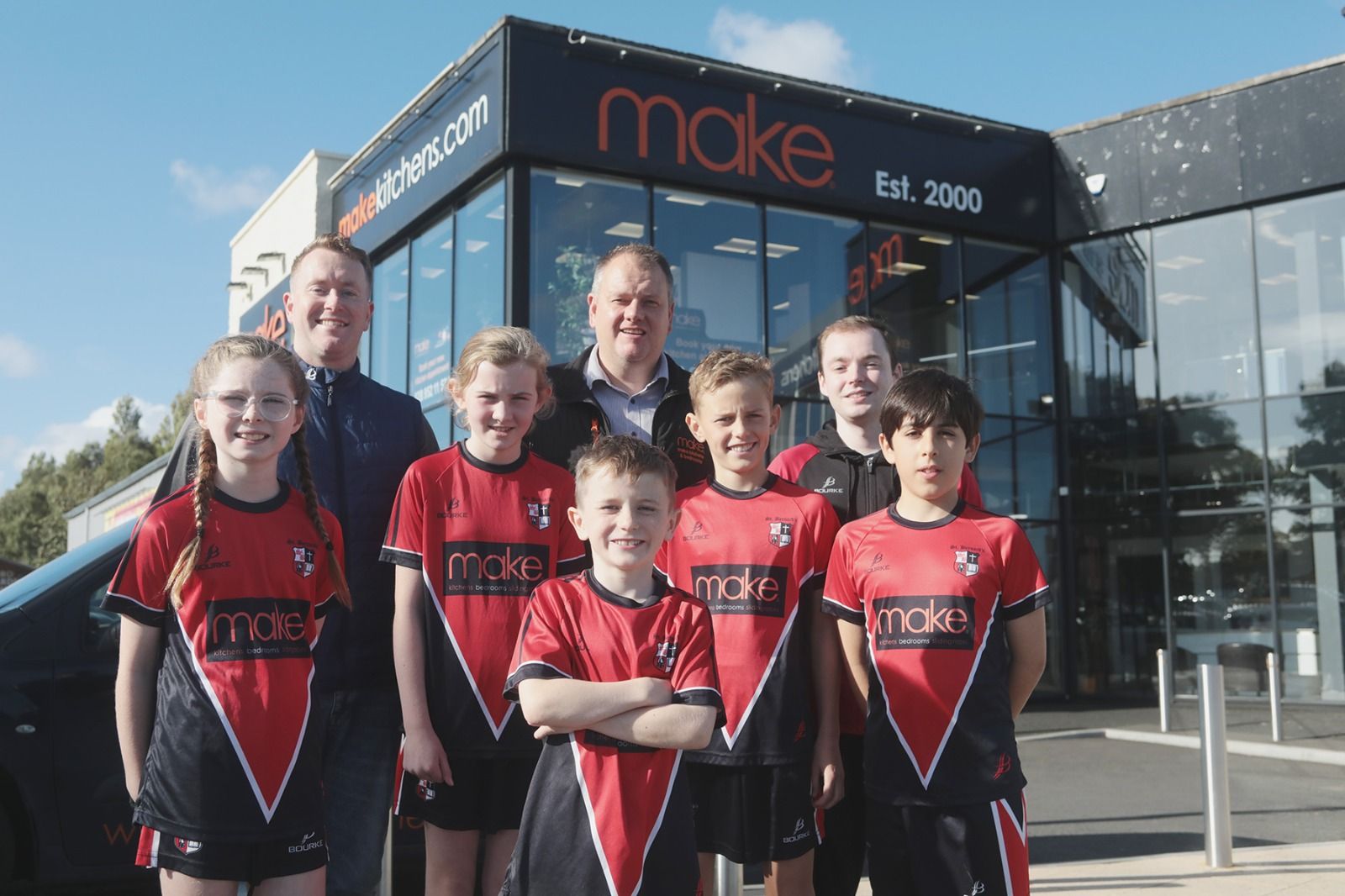 NEW KIT: Simon Doherty (Bourke Sports), Brendan McAllister (Make Kitchens) with St Bernard\'s PS teacher Connor McGowan with pupils Isla, Aoife, Cillian, Omar and Ben