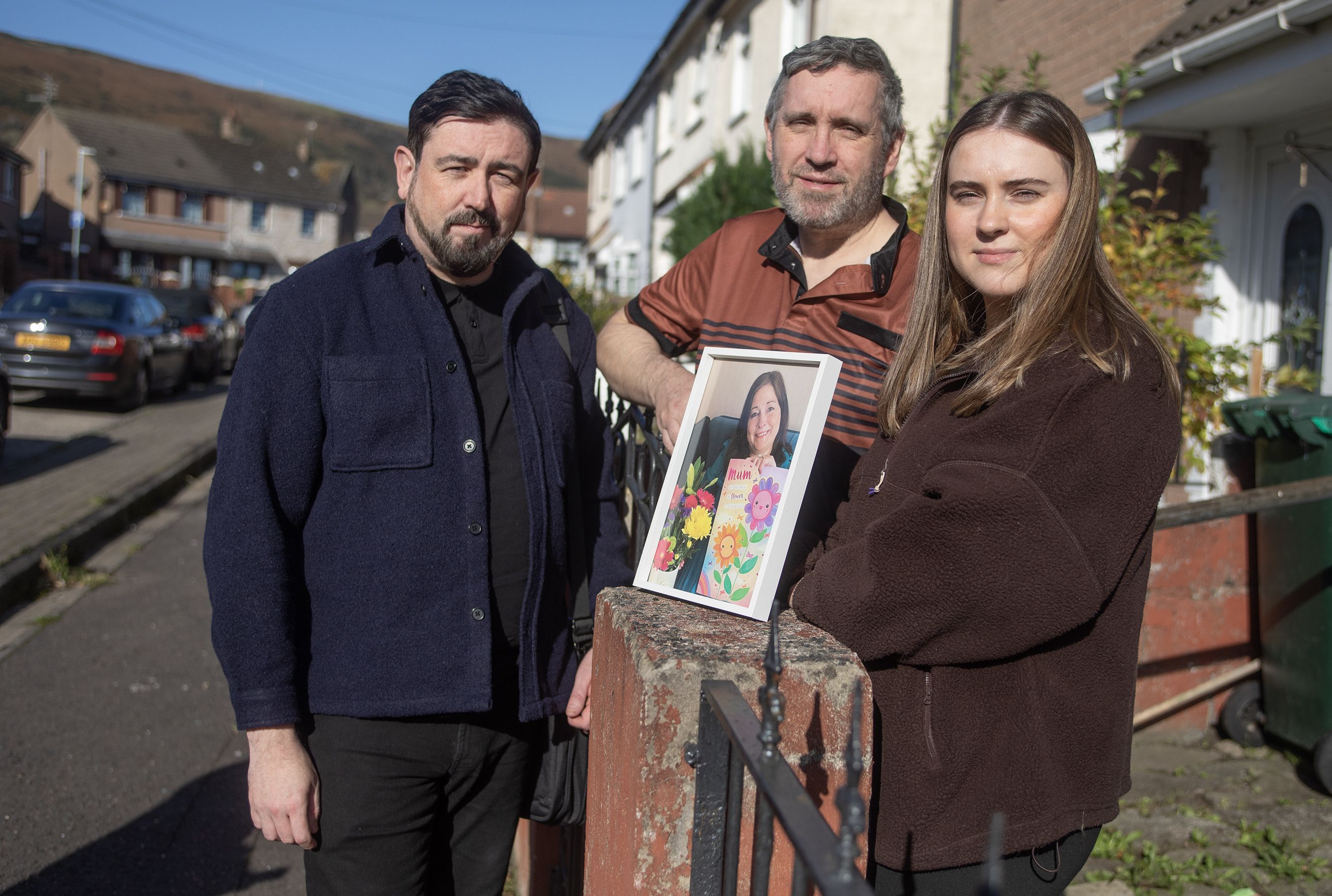 CAMPAIGN: Damien and Aimee Donnelly hold a framed photograph of Philomena, alongside SDLP councillor Paul Doherty