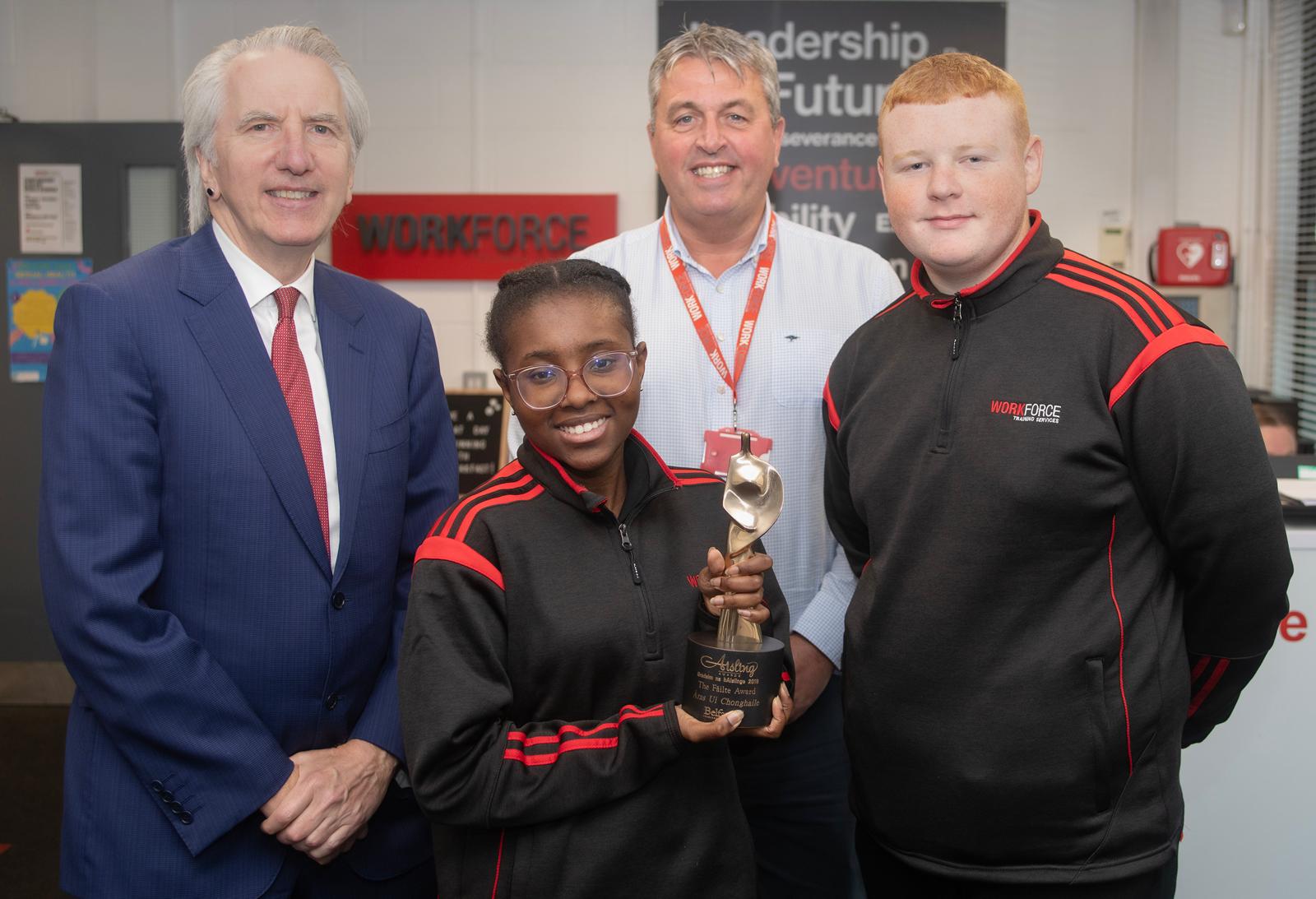 FROM LITTLE ACORNS: Showing off their 2023 Aisling Award to Máirtín Ó Muilleoir are Paul Boyle of Workforce and trainees Joice Nichole Goncalves and Michael Gallagher