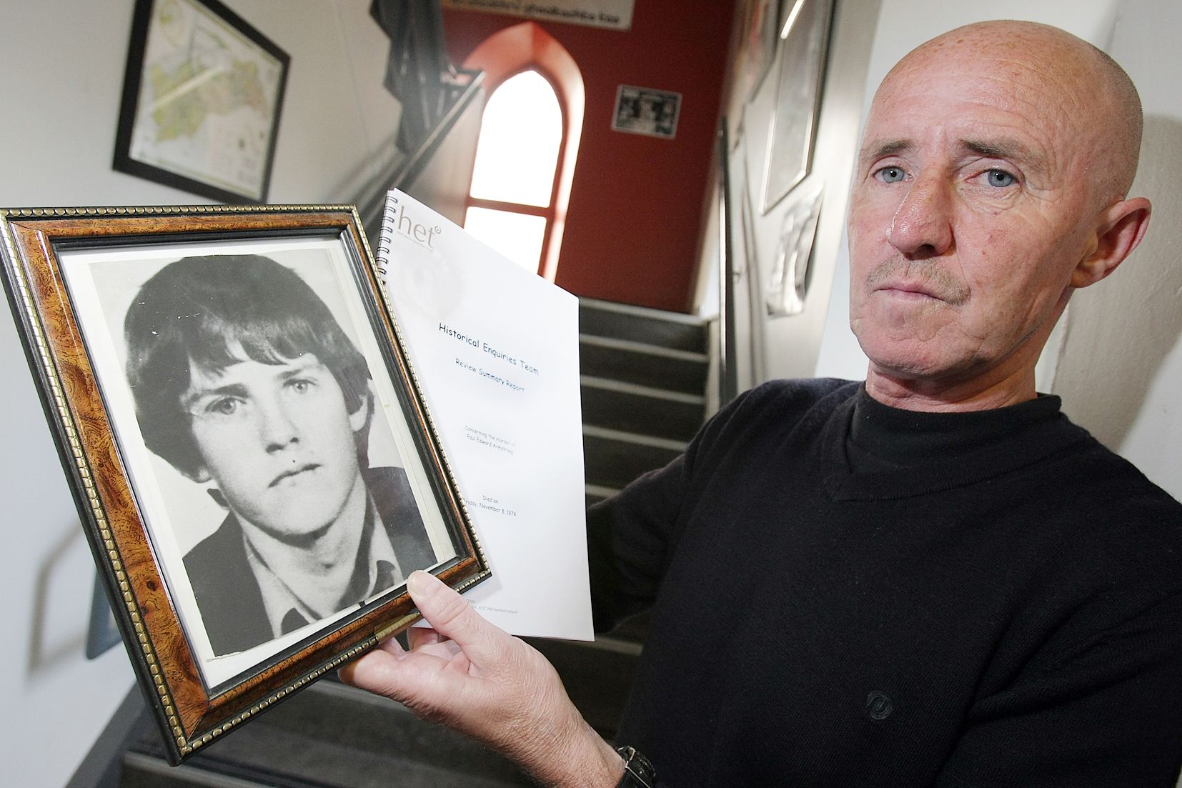 BROTHER: Gerry Armstrong pictured here with a photo of his brother Paul has announced he is stopping speaking about Paul\'s murder