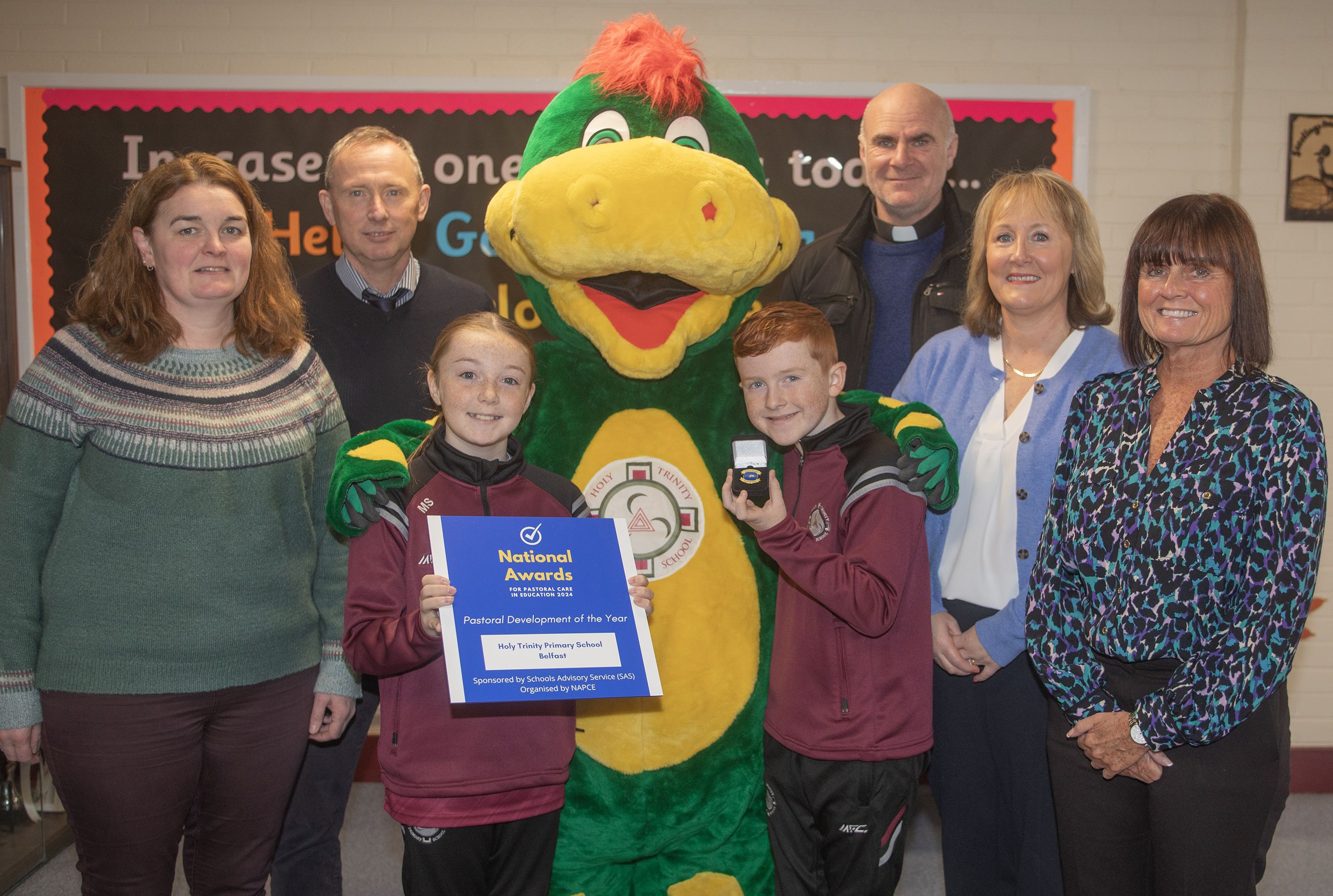 ESAFETY: Mairead McLoughlin, Chris White, Maisie Smith (P7), eSafetySaurus, Harry McArdle (P7), Fr Brendan Mulhall, Martine Rooney and Headmaster Fiona Boyd of Holy Trinity PS