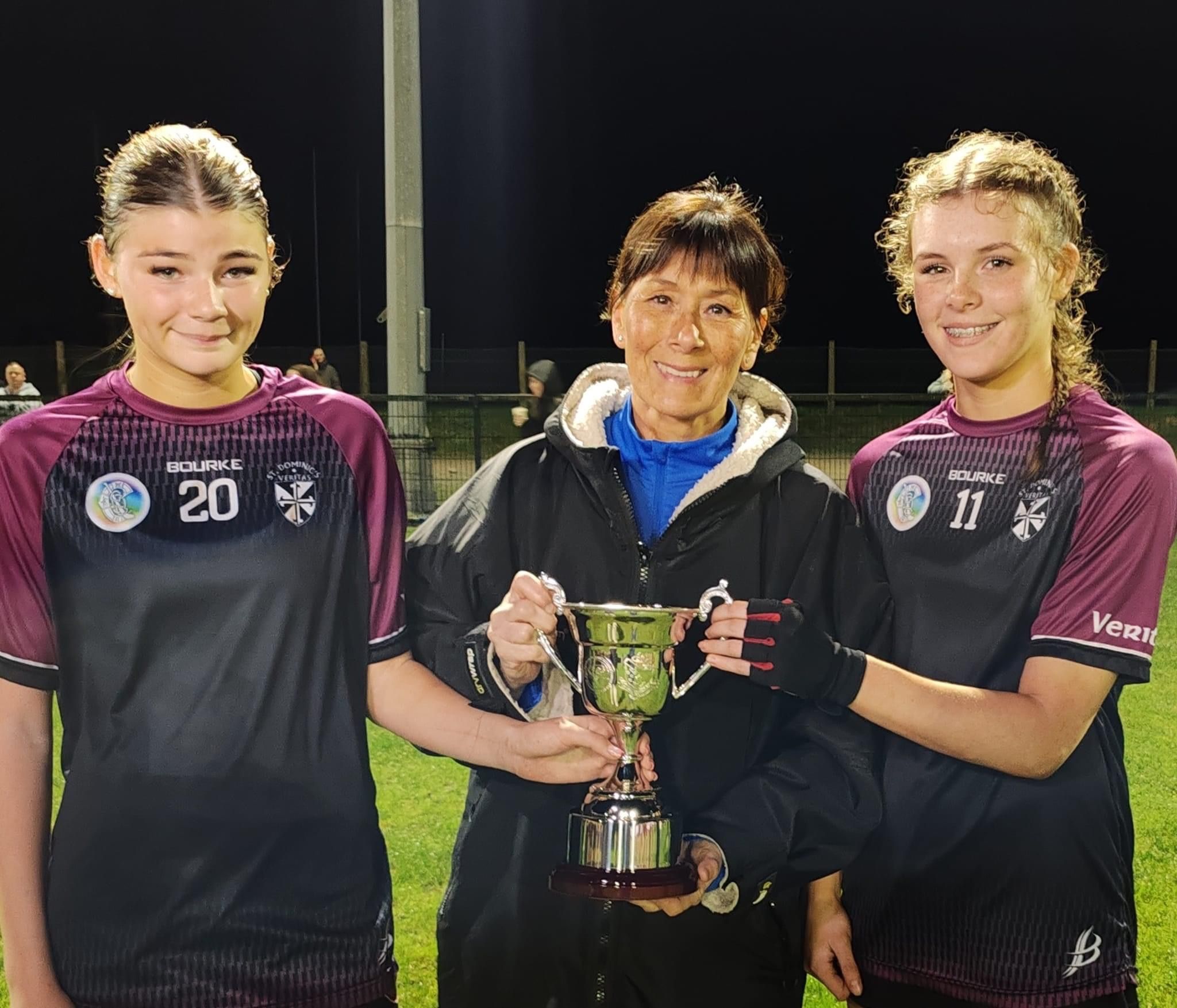 CHAMPS: Mrs Julie Cunningham presents joint captains Aoife Fitzsimons and Amy Gault with the Dr Cunningham Cup