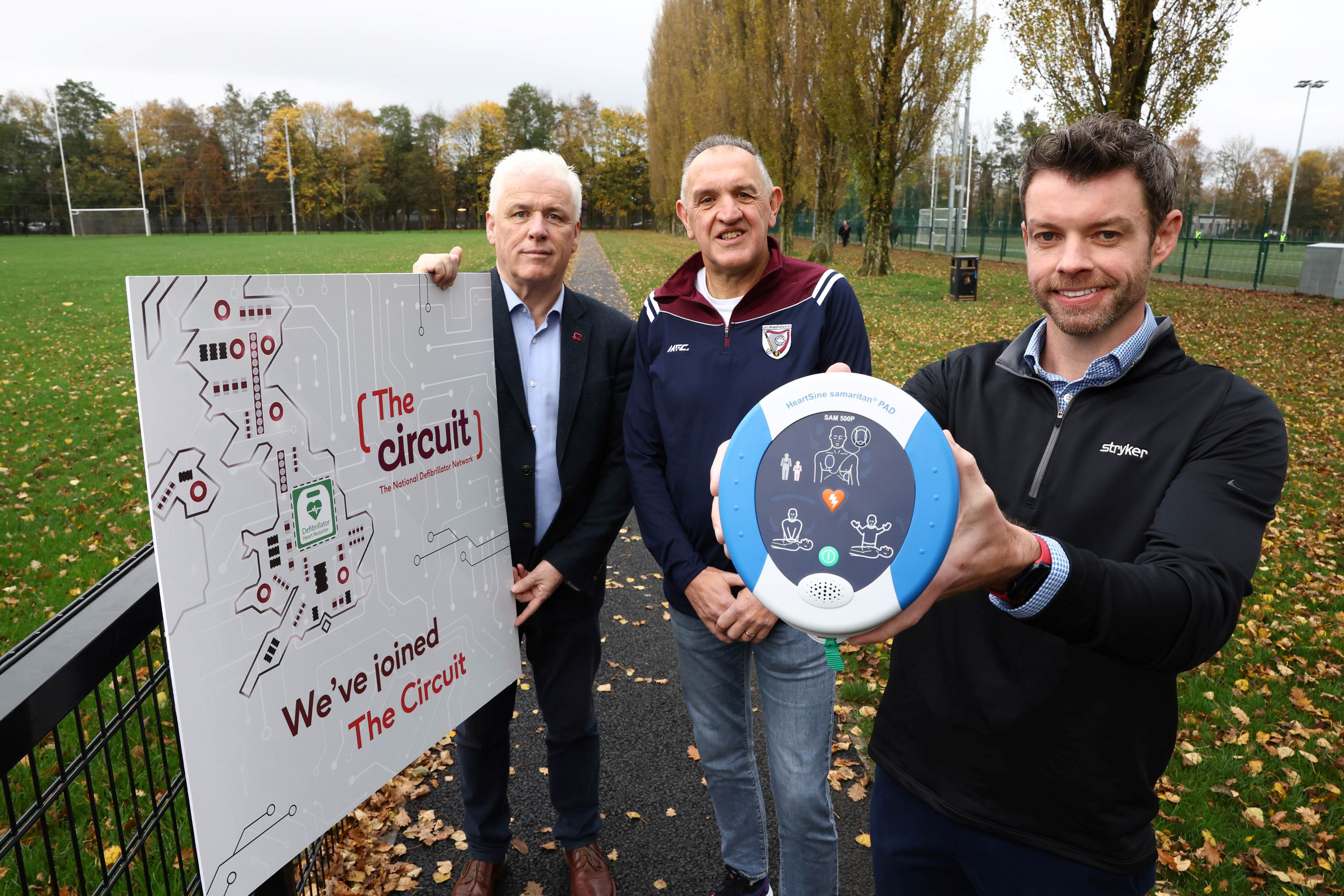 LIFE-SAVING: John Deery (centre) was saved by Peter O\'Hare (right) using a defibrillator after John collapsed during the Belfast marathon; on the left is head of BHF NI Fearghal McKinney
