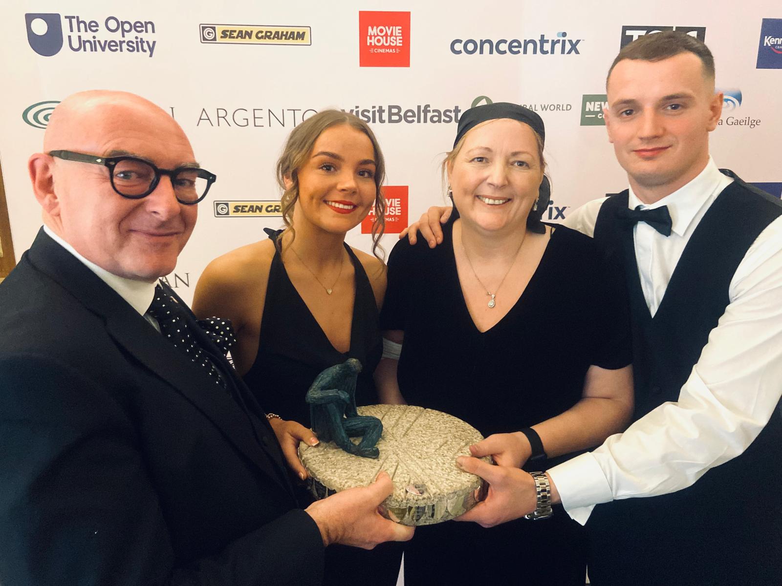 PERSON OF THE YEAR: Máire Thompson with children Gabrielle and Harry  is presented with her award by John D\'Arcy from Open University