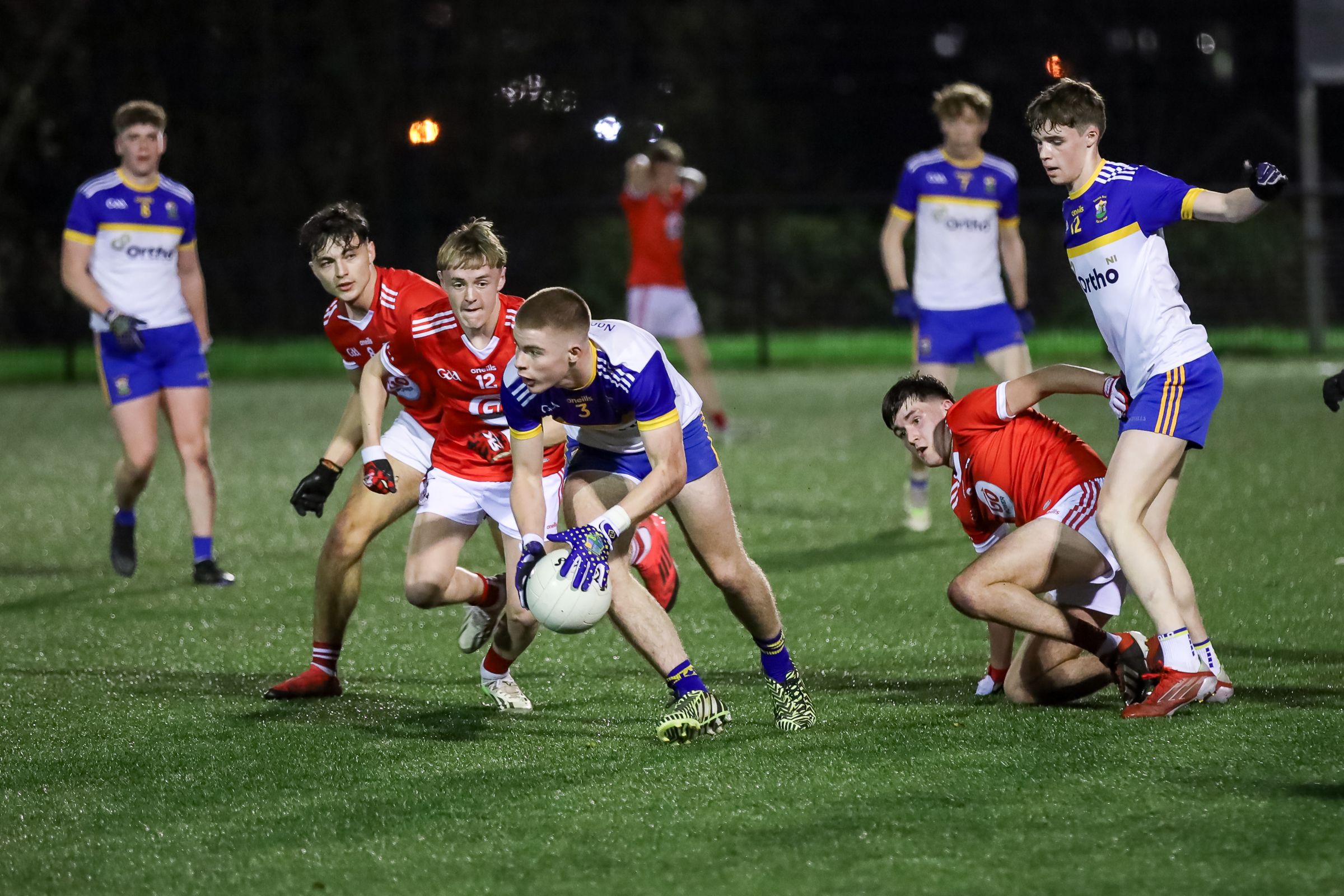 Sonny Doyle breaks away from Lorcan Higgins and Jude Beattie at Spórtlann on Saturday