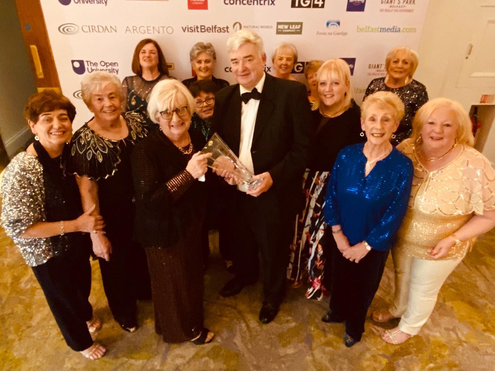 CHAMPS: The ladies of St Gall\'s Hen Shed, this year\'s recipients of the Cirdan Health & Well-Being Award receive their trophy from Cirdan founder Hugh Cormican