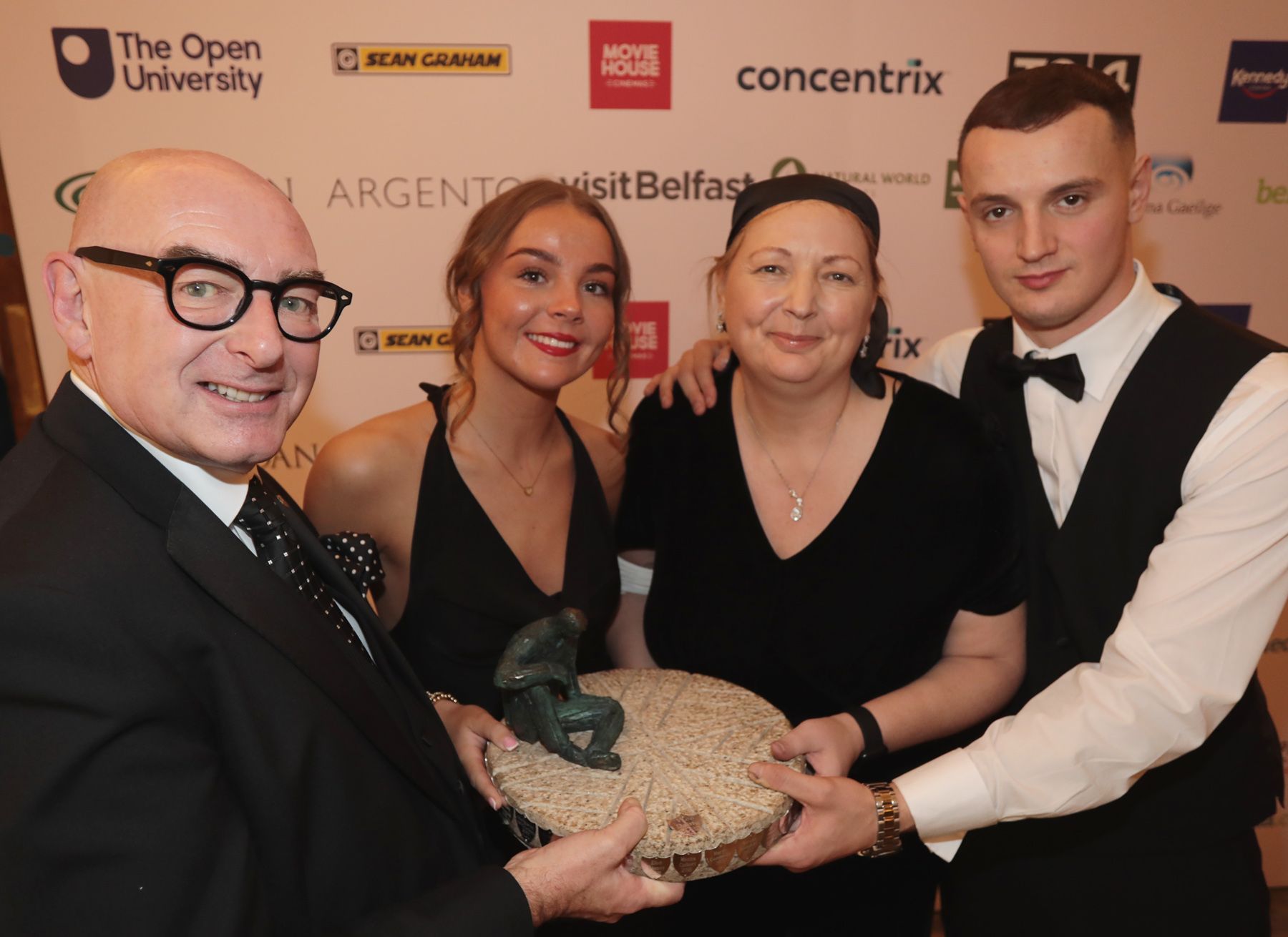 Person of the Year: Máire Thompson with children Gabrielle and Harry is presented with her award by John D'Arcy from Open University